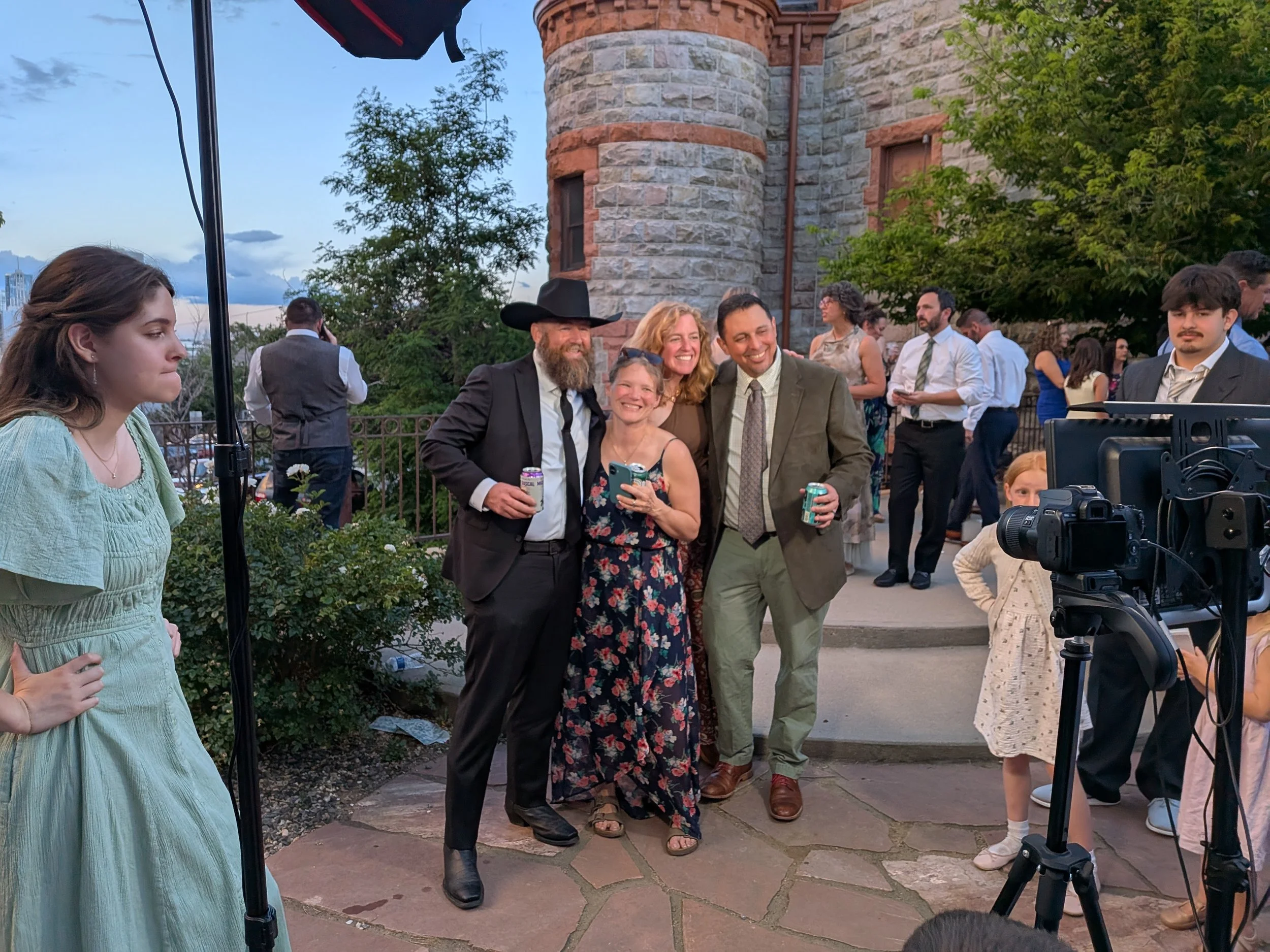 Individuals enjoying a photobooth or photography setup at a wedding