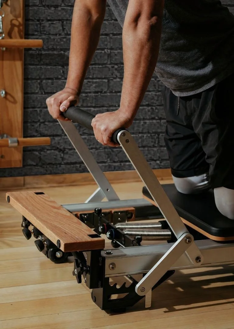 Man performing Pilates-based movement training focused on core strength, posture, and functional stability at Aptare Lab, fitness and wellness center in Indian Land SC.