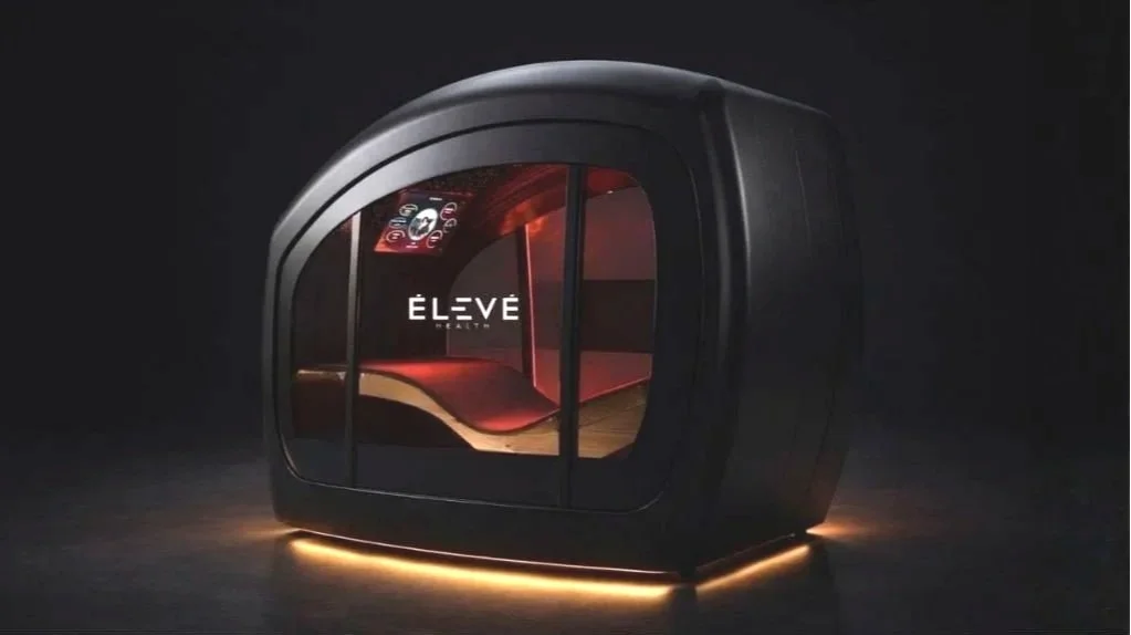 Inside fitness center Aptare Lab in Indian Land SC, the all-in-one longevity pod at Eleve Longevity Lounge features red light therapy, oxygen therapy, thermal heat, aromatherapy, and salt therapy for full-body recovery and performance optimization.