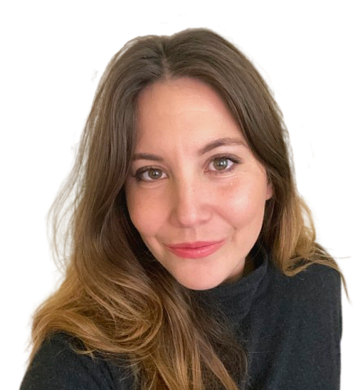 Close-up of a woman with long, wavy light brown hair, smiling, wearing a black turtleneck, against a plain background.