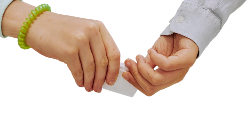 Two people exchanging an envelope, one wearing a green bracelet and the other a white shirt with rolled-up sleeves.