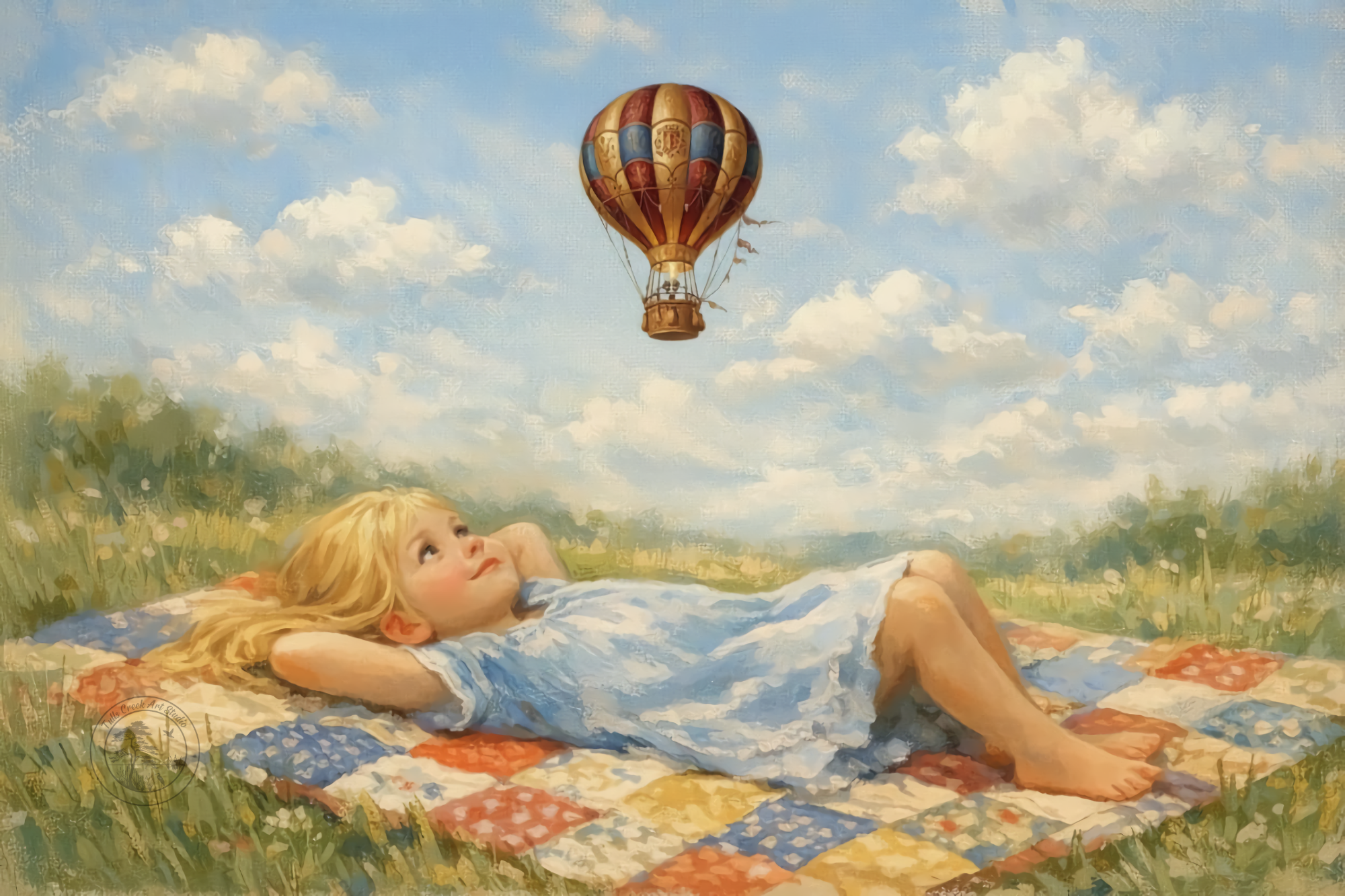 A young girl with blonde hair lying on her back on a colorful quilt in a grassy field, gazing up at a hot air balloon floating in the sky surrounded by clouds.