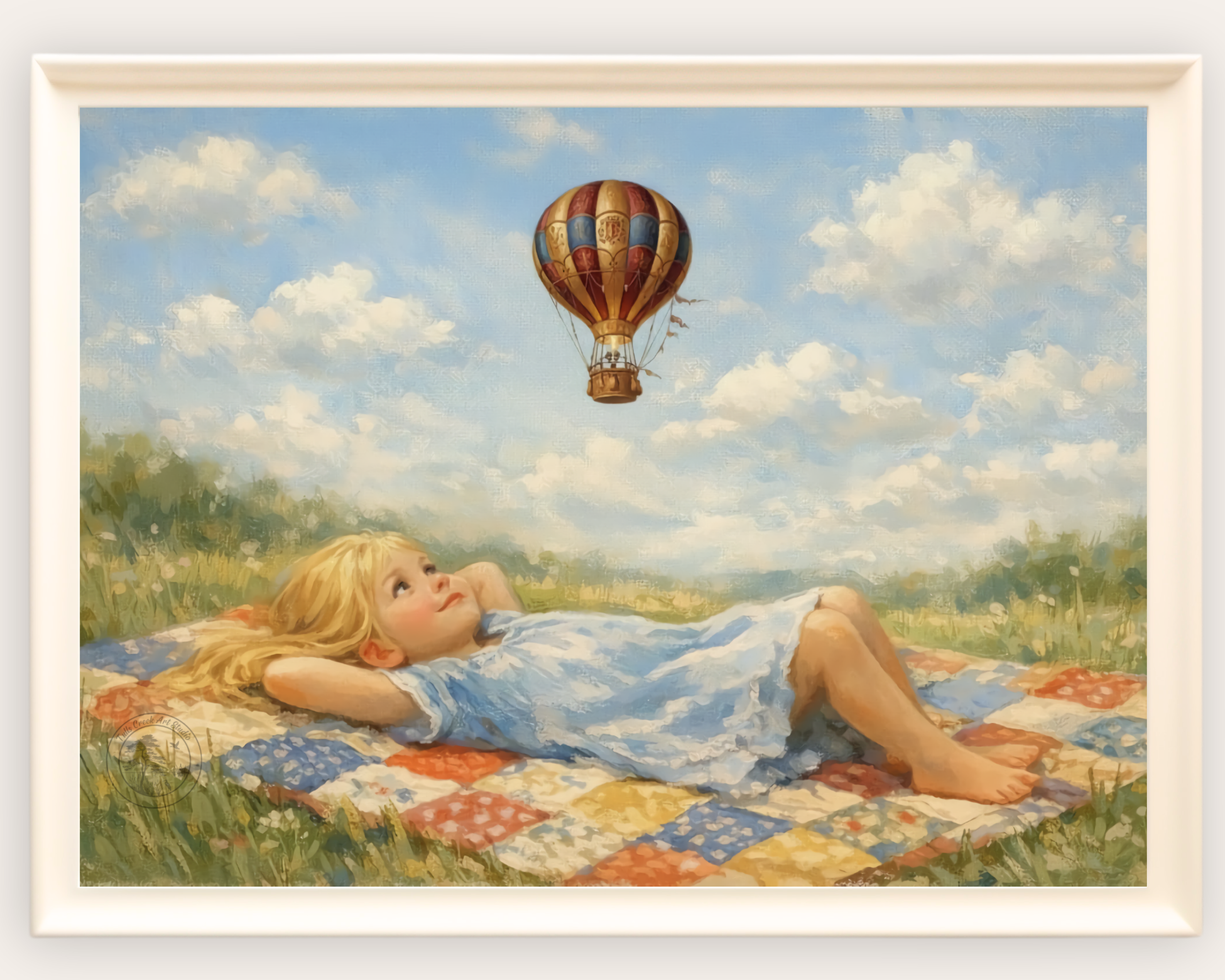 A girl lying on a colorful quilt in a grassy field, looking up at a hot air balloon floating in the sky with fluffy clouds.