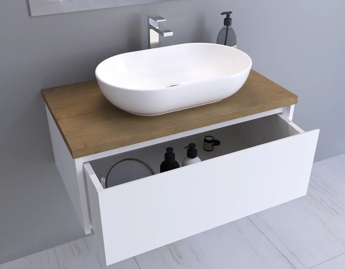Bathroom vanity with a white vessel sink on a wooden countertop and a drawer with toiletries inside.