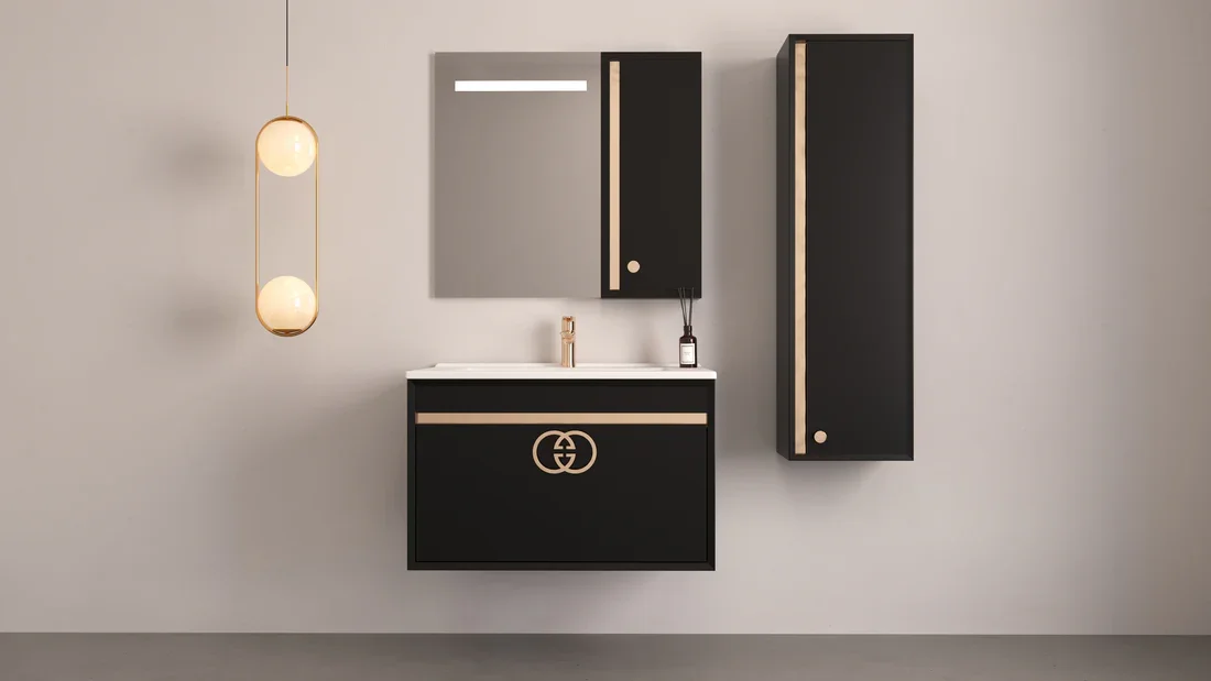 Modern bathroom vanity with black cabinets featuring beige accents, a mirror, and a wall-mounted cabinet, with a pendant light hanging to the left.
