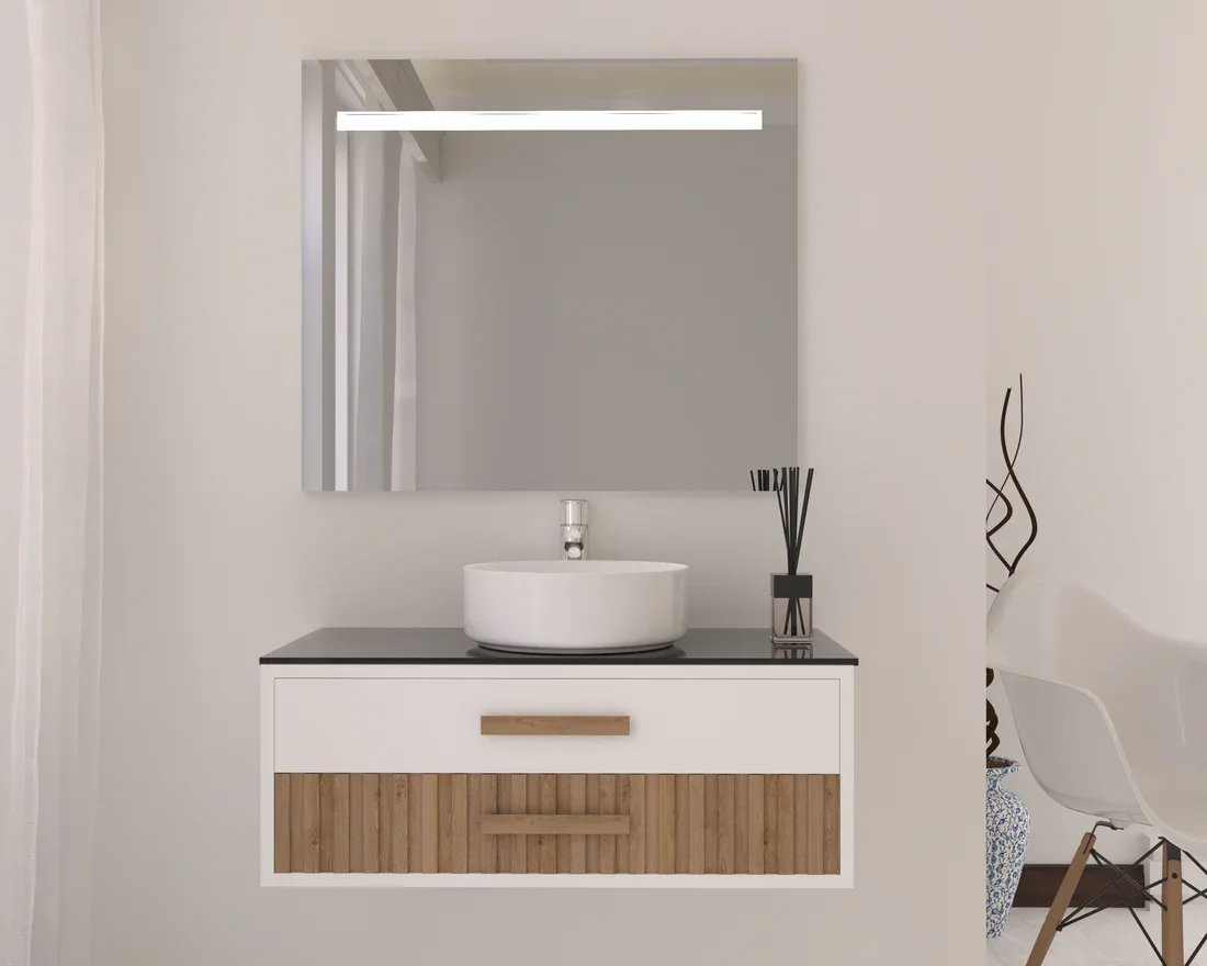 Modern bathroom vanity with a round white ceramic vessel sink, black countertop, large wall mirror, and black reed diffuser, with a decorative tall vase on the side and a white chair nearby.