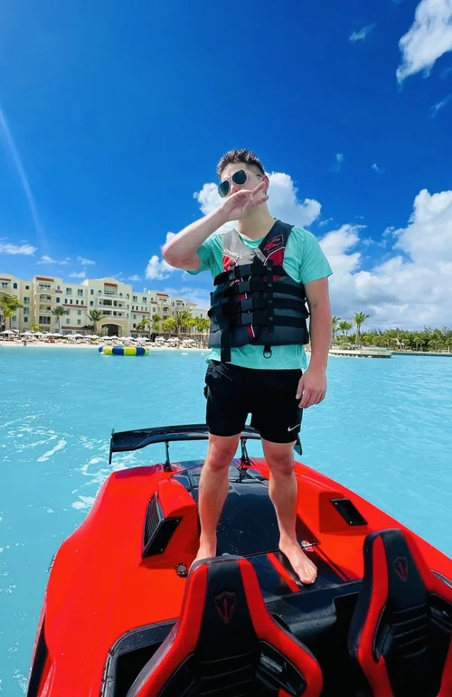 Red jet car speeding across turquoise water in Miami