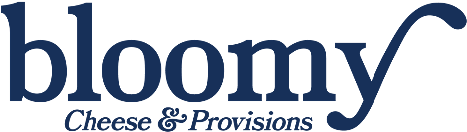 Logo for 'bloomy Cheese & Provisions' featuring the word 'bloomy' in large blue letters with a stylized letter 'y' resembling a checkmark, and 'Cheese & Provisions' in smaller blue cursive underneath.