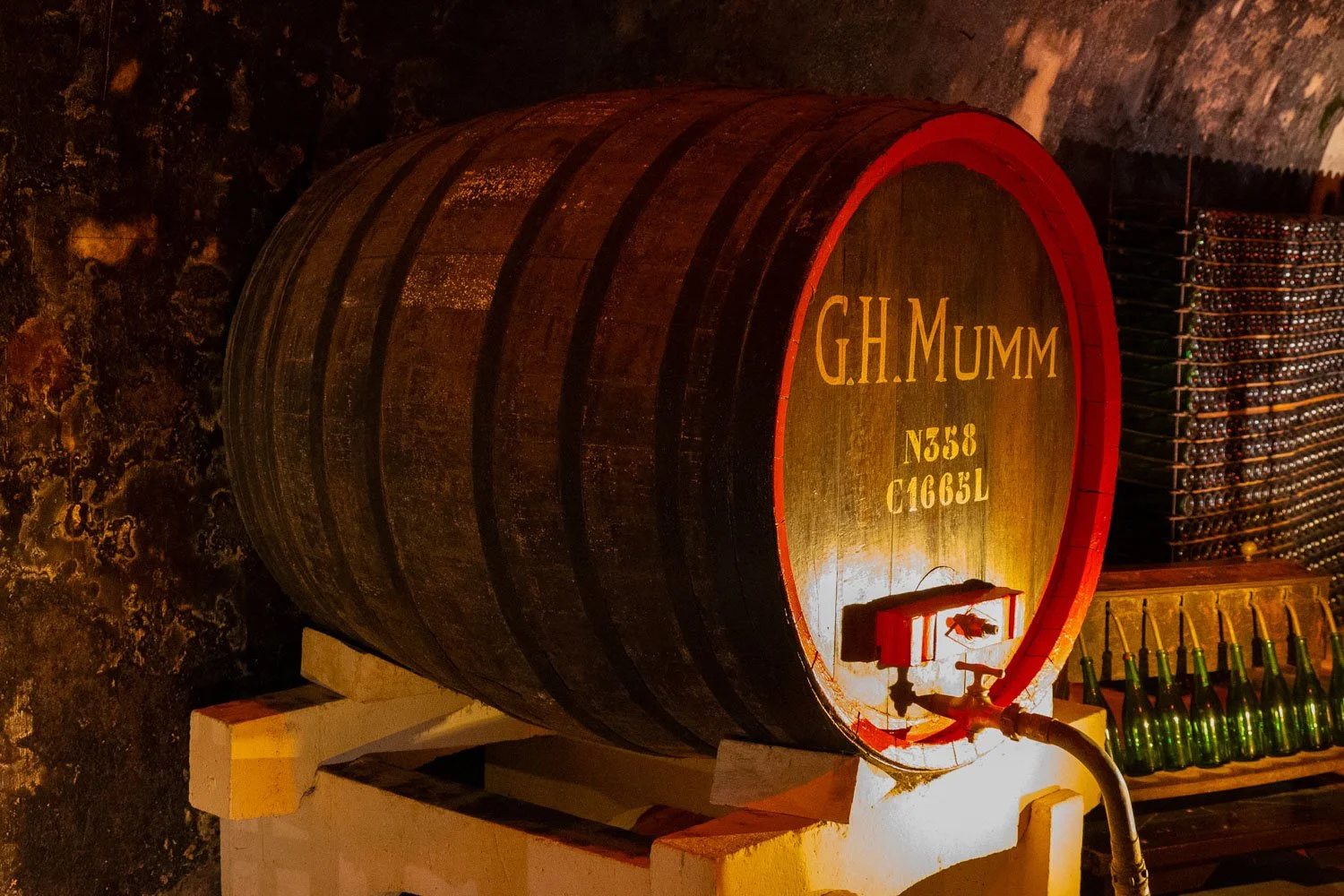 Side view of a large G.H. Mumm champagne barrel in the underground cellars in France.