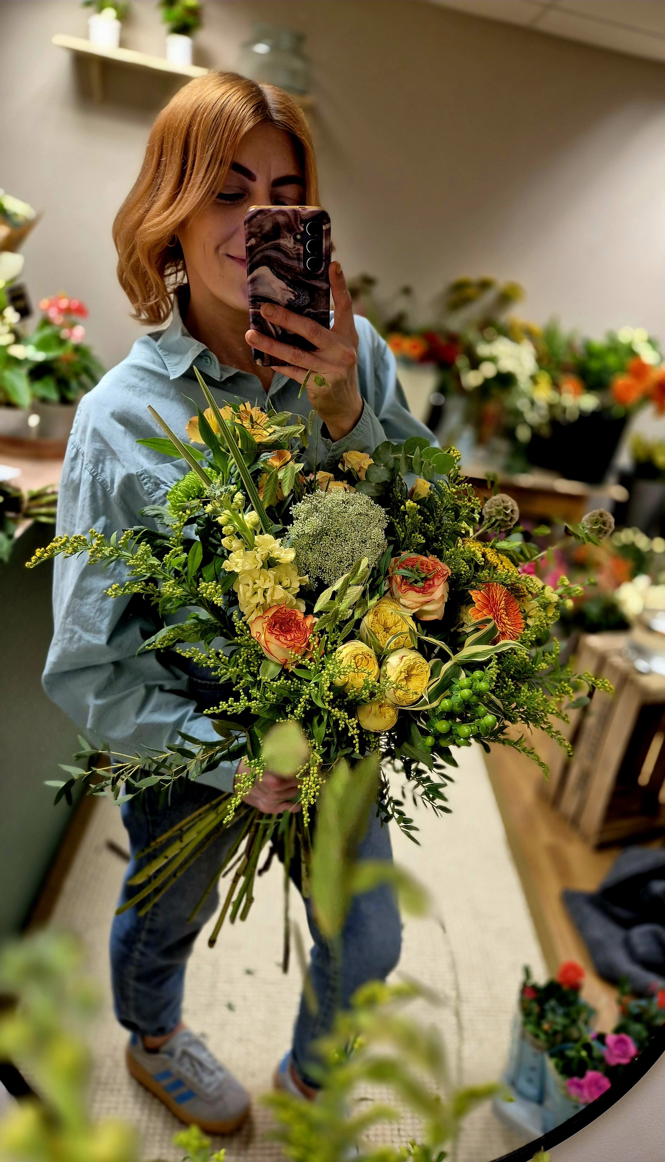 Florist holding a Mother's Day bouquet at Poetry in Flowers in Hednesford Staffordshire.