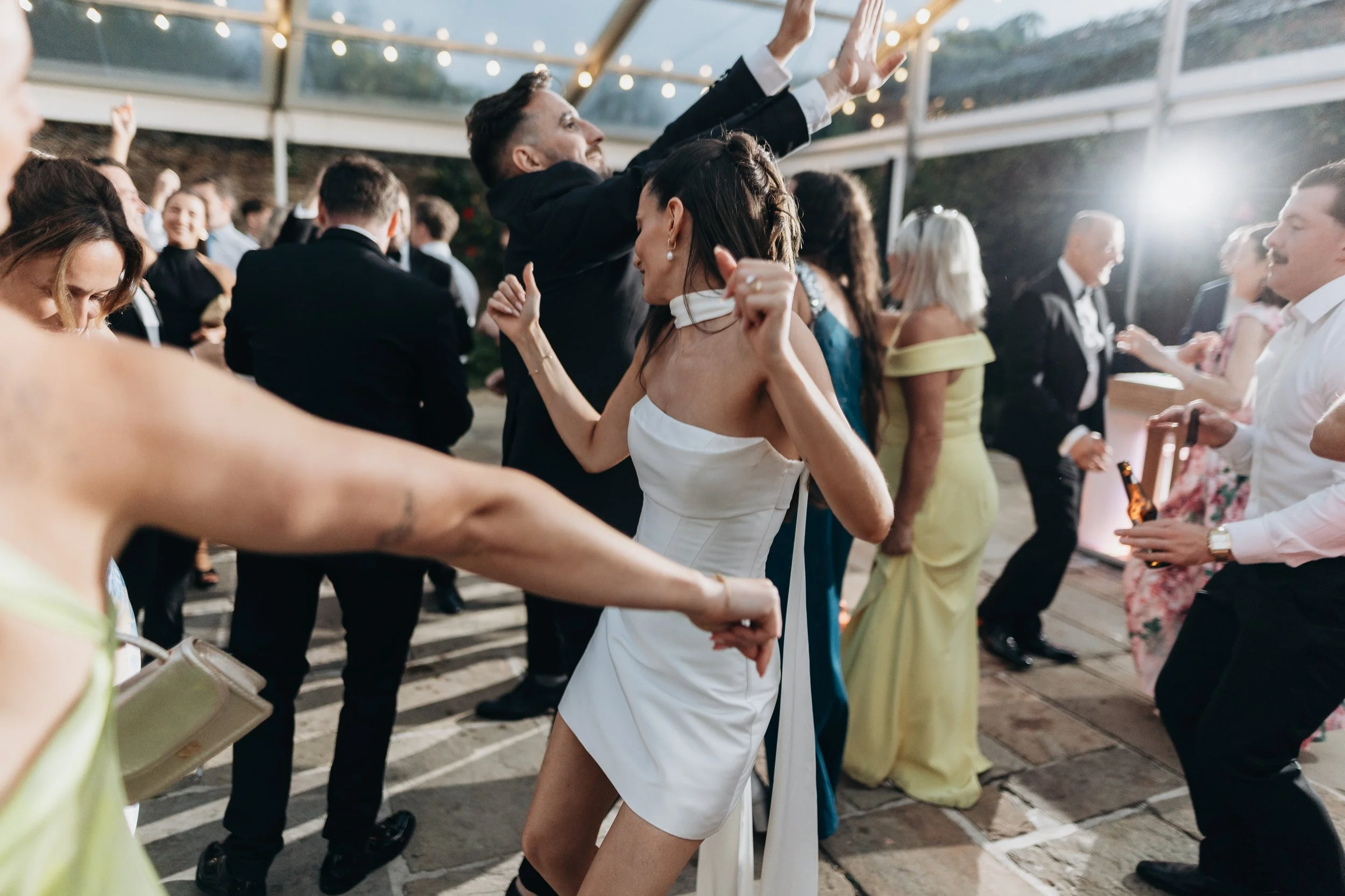 Wedding couple’s first dance in the Rose Garden Room at Kingston Estate, surrounded by guests during the evening celebration.
