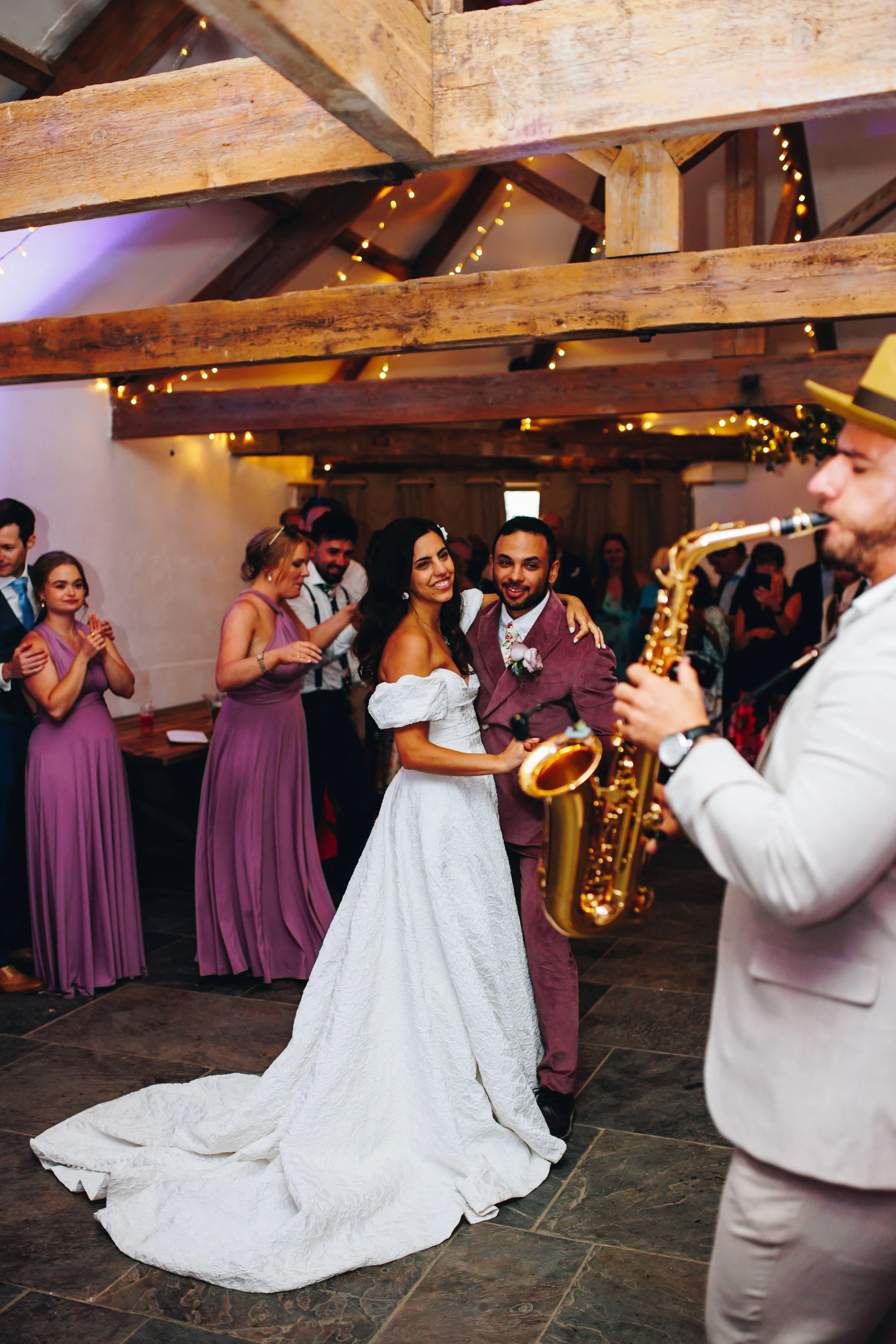 Happy couple enjoying DJ and sax for their first dance at Wonwood Barton