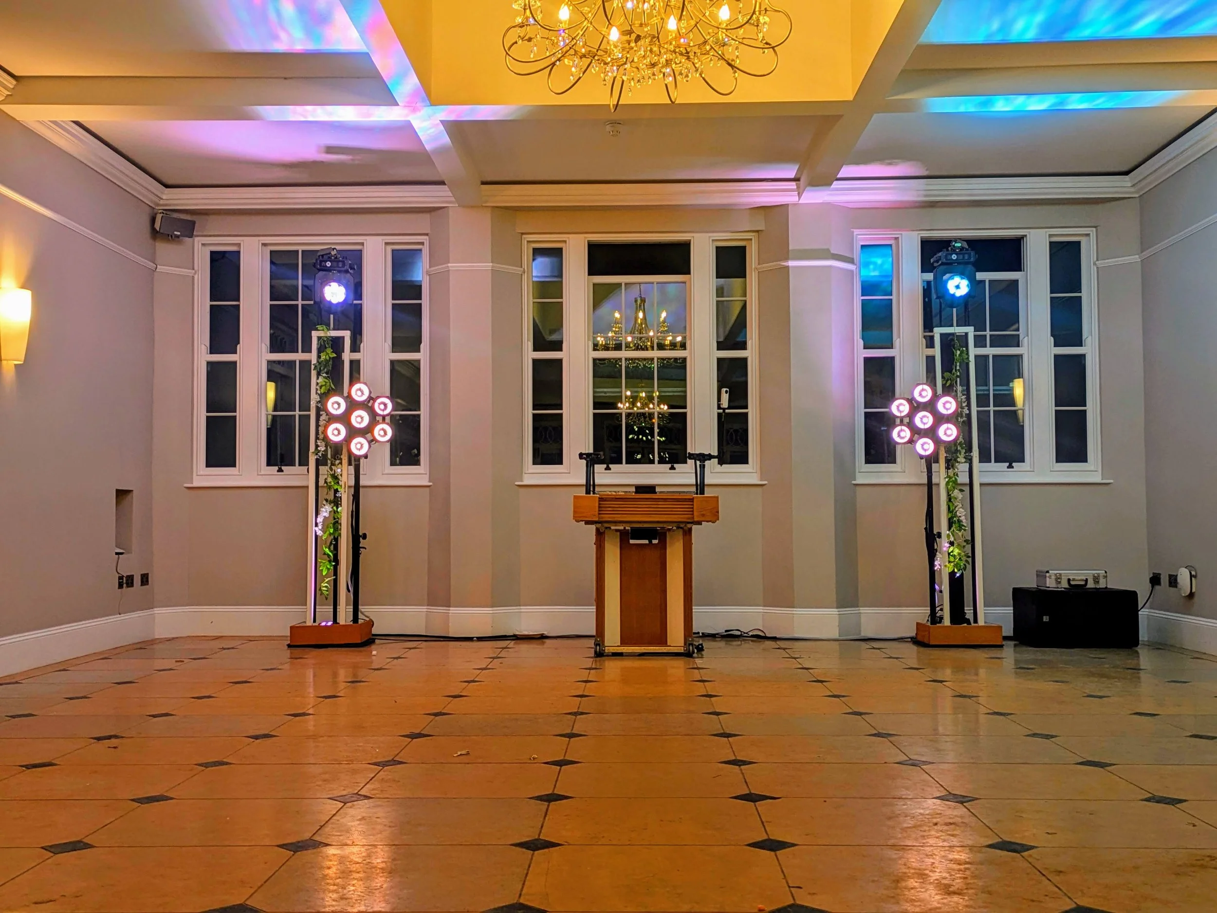 Wedding DJ setup in the ballroom at Rockbeare Manor with elegant lighting and oak DJ console ready for the evening party