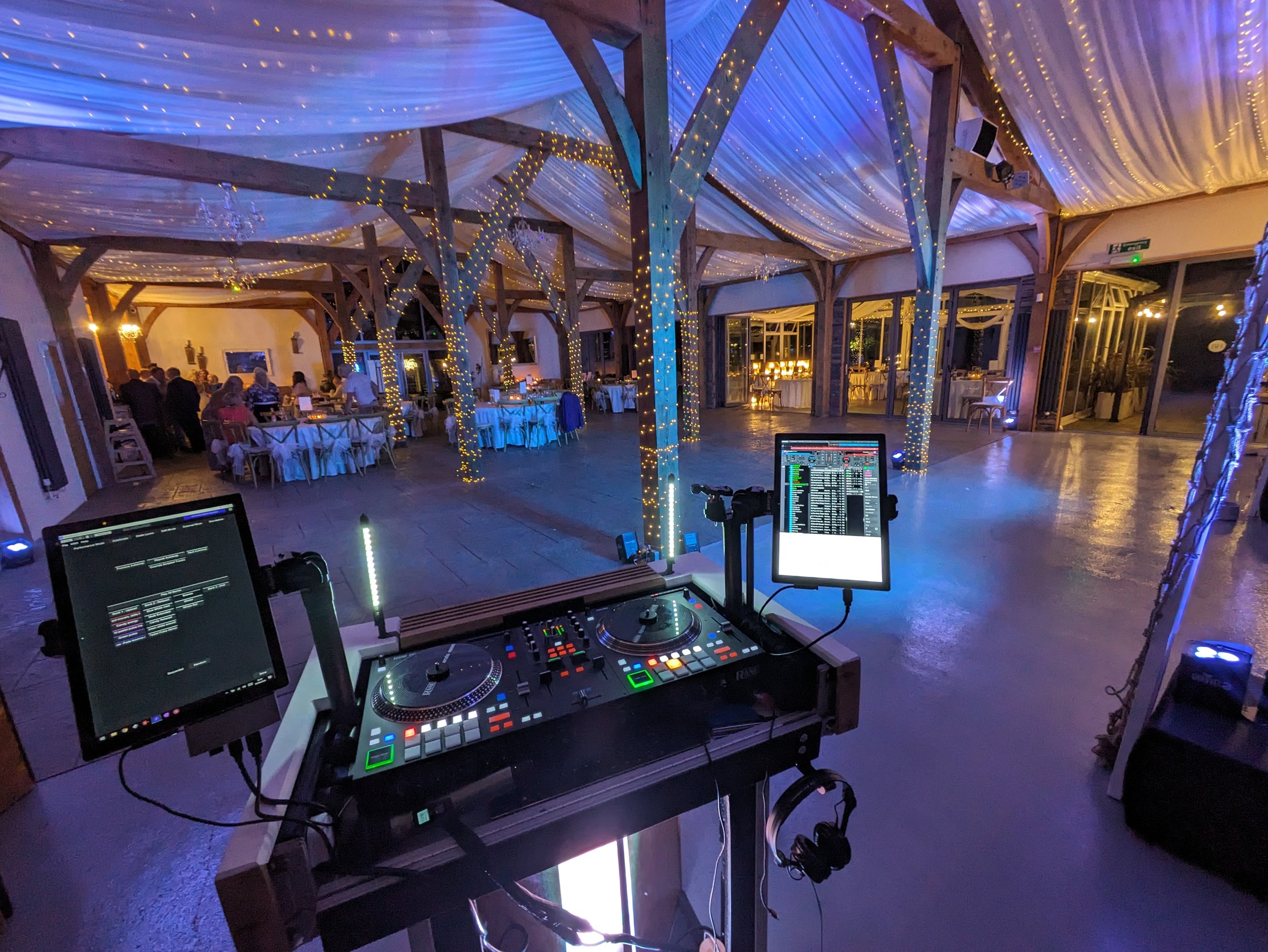 An empty wedding dance floor seen from the DJ’s perspective before the party begins