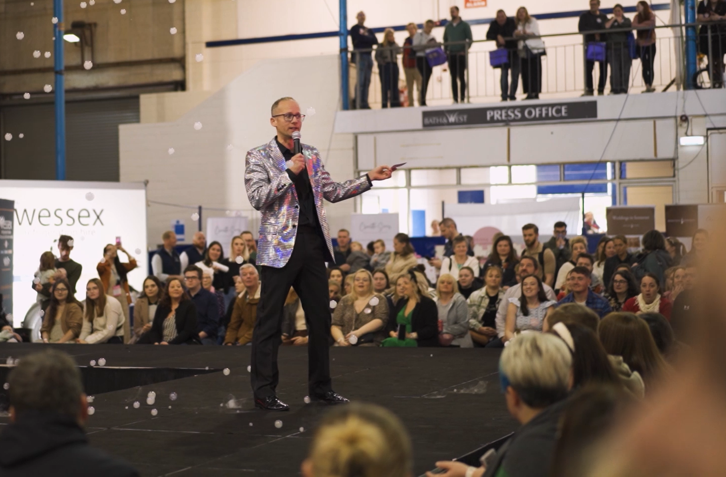 A wedding host using the microphone to guide guests through the celebration