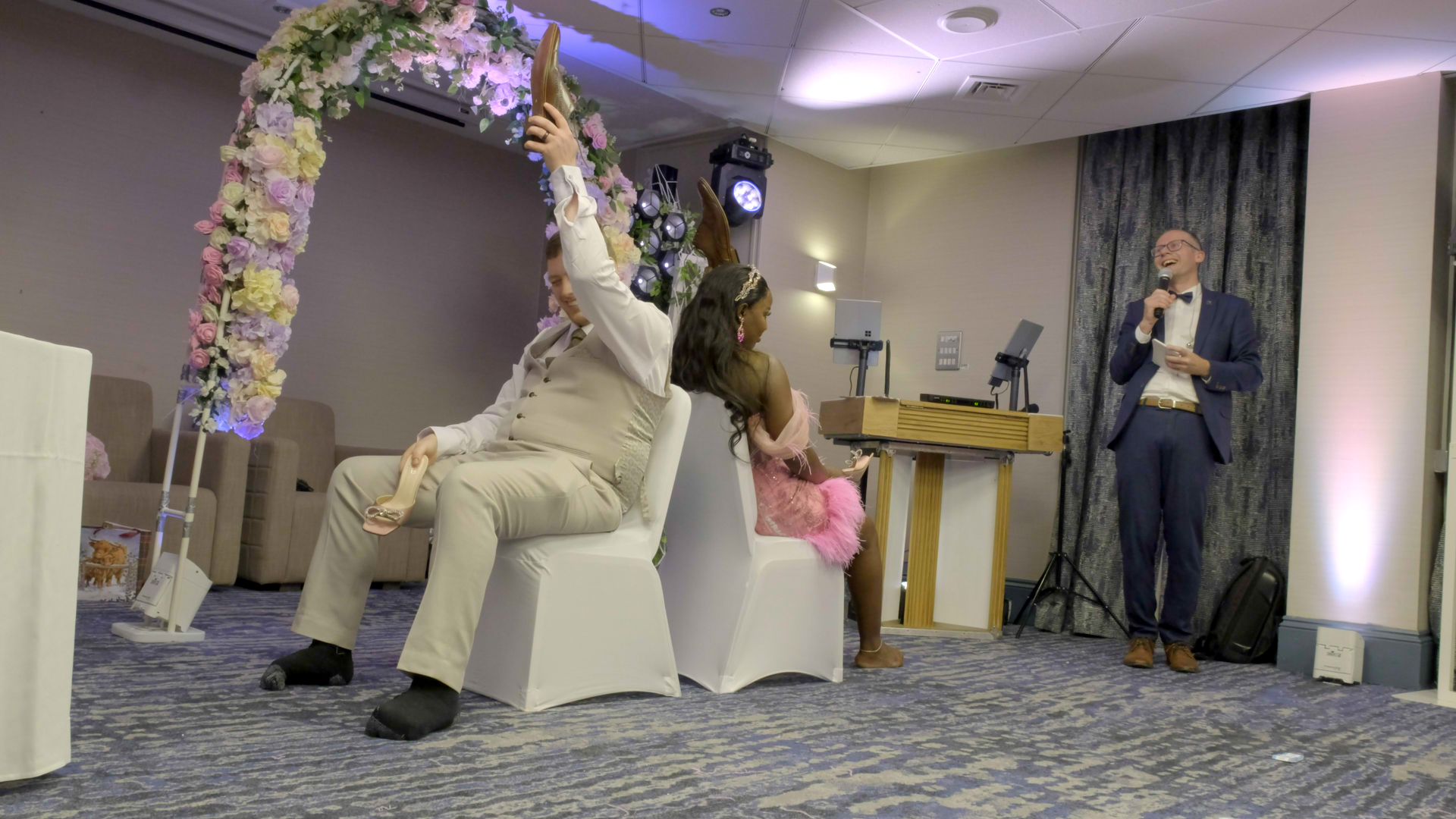wedding couple playing the shoe game, or 'Mr & Mrs' at their wedding reception