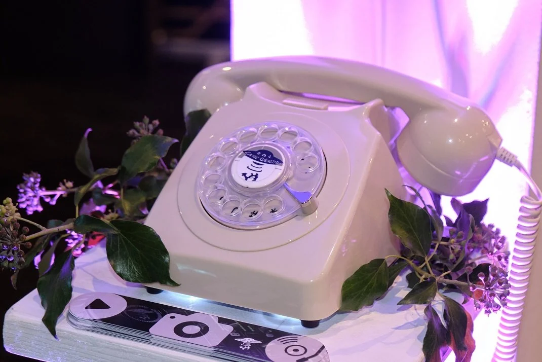 A PhoneOgram audio guestbook, a vintage white rotary dial telephone, capturing messages from wedding guests as a keepsake.