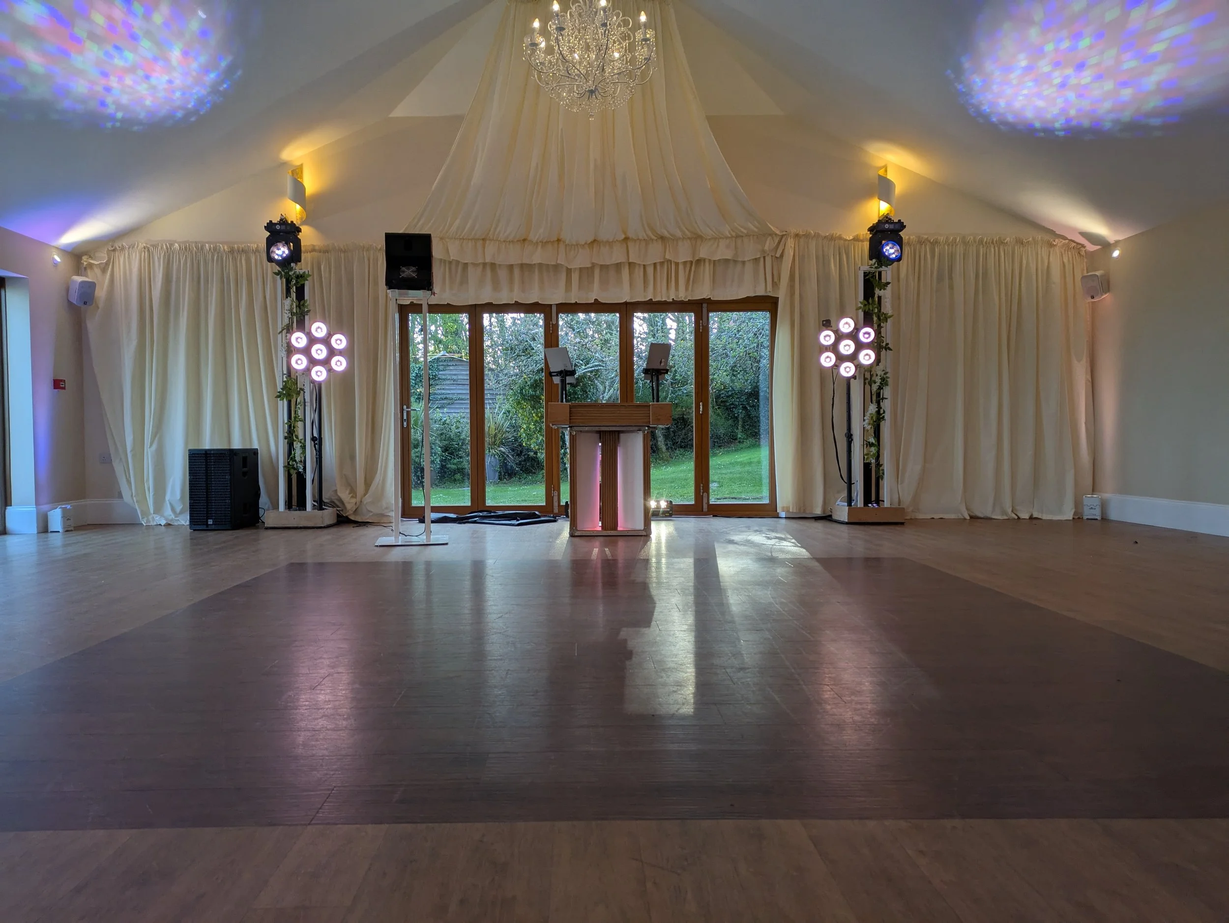 Elegant wedding DJ setup at Tredudwell Manor with stylish lighting and professional sound equipment.