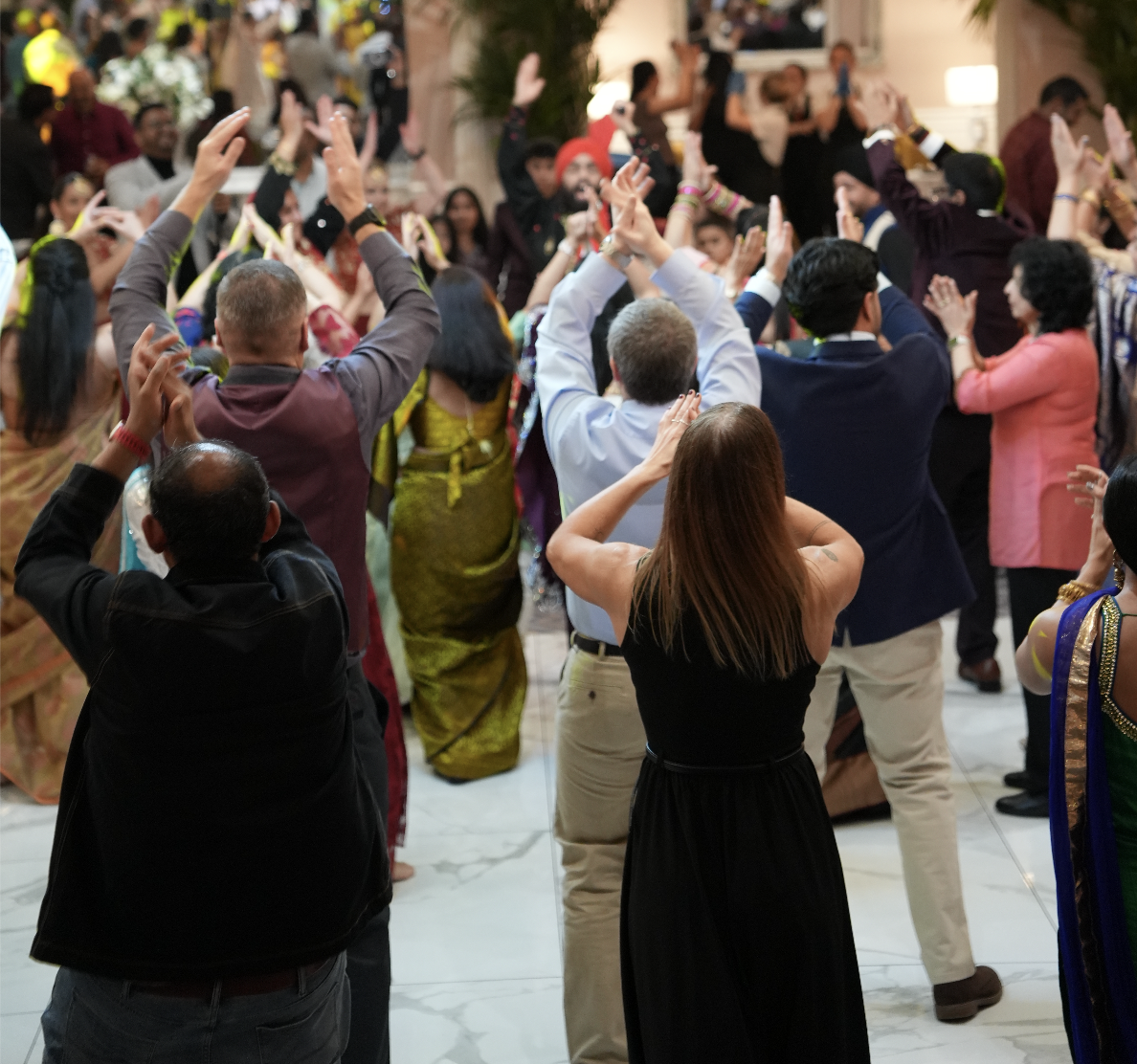 People dancing and celebrating at a festive indoor event.