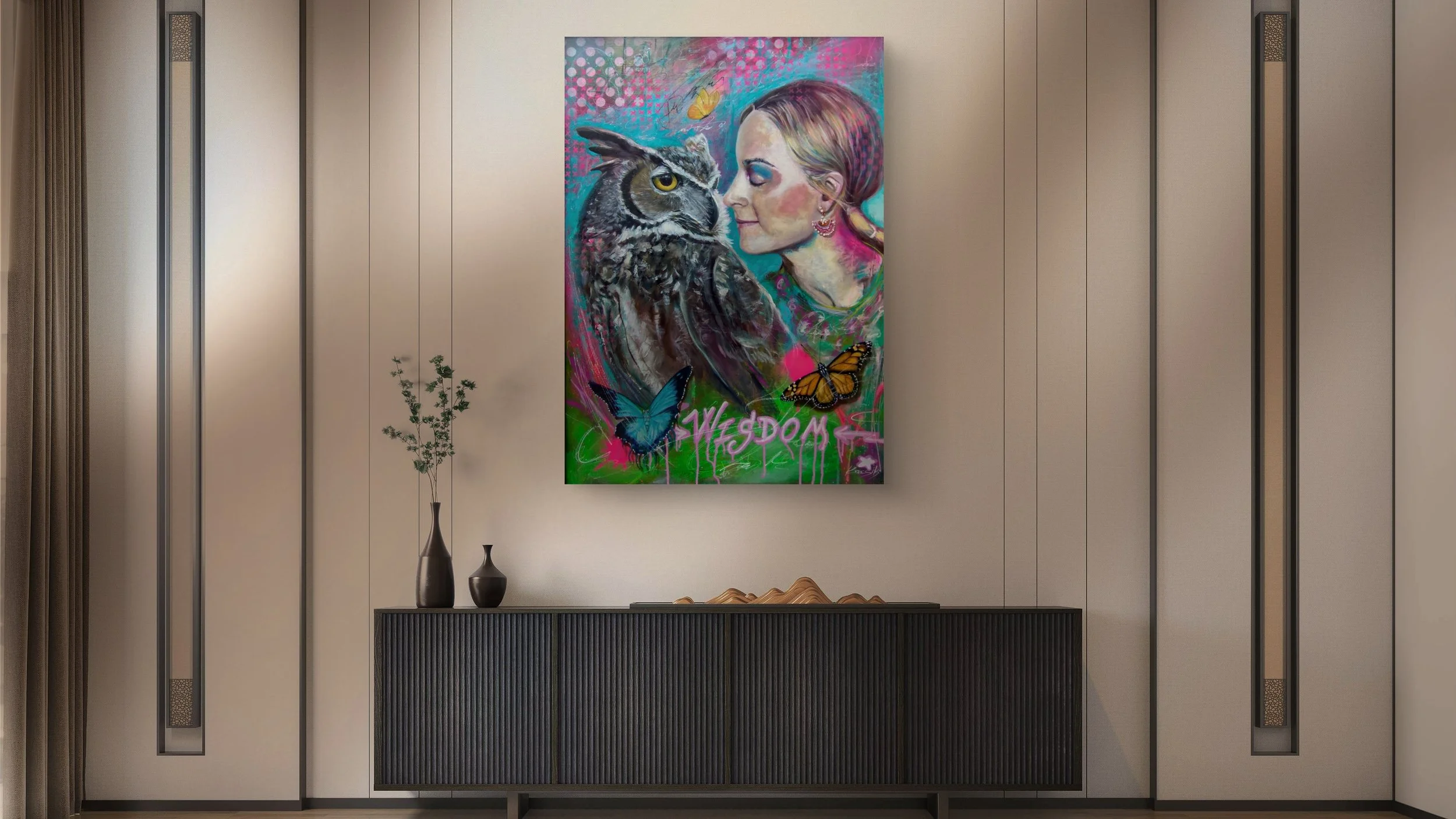A modern interior wall with a colorful abstract painting of a woman and an owl, surrounded by butterflies, hanging above a black sideboard with vases and decor.
