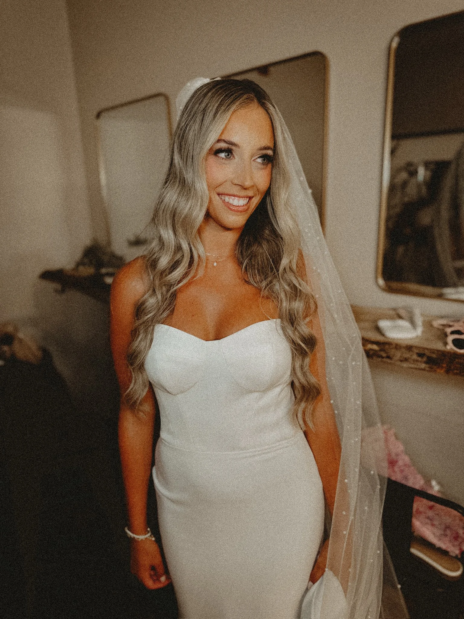 A gorgeous Content Queen bride moments before walking down the aisle on her wedding day as she smiles for her content creator