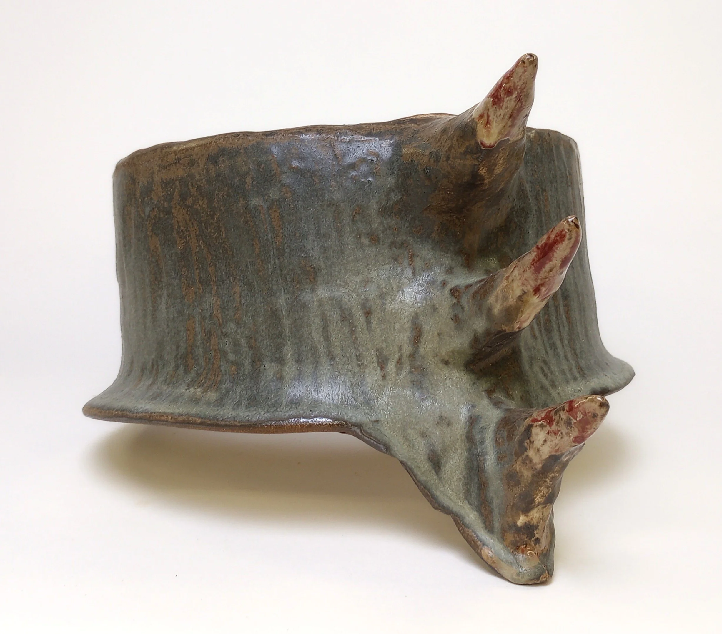 Back of a mask with three large spikes coming out of it.