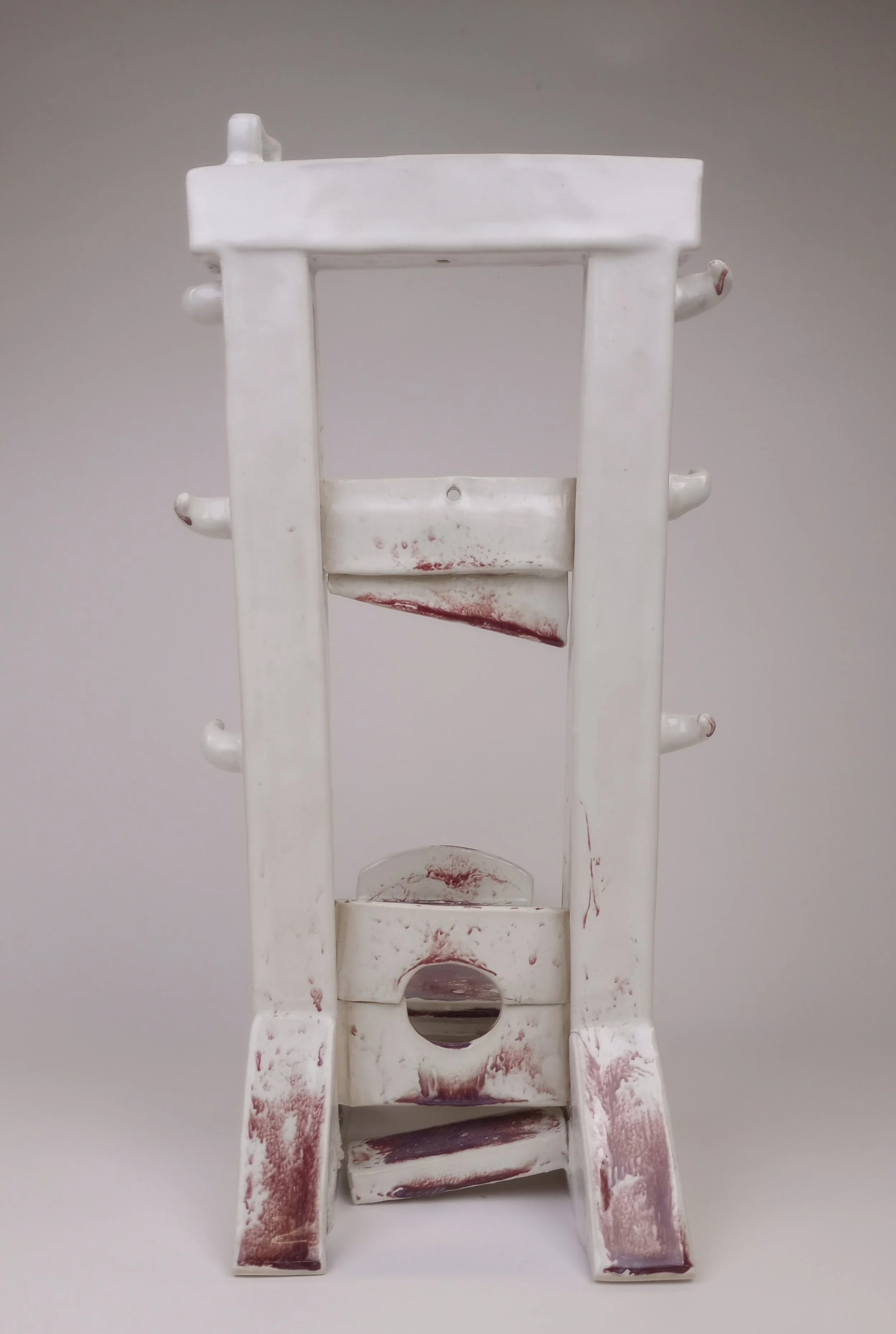 Back view of white ceramic guillotine.
