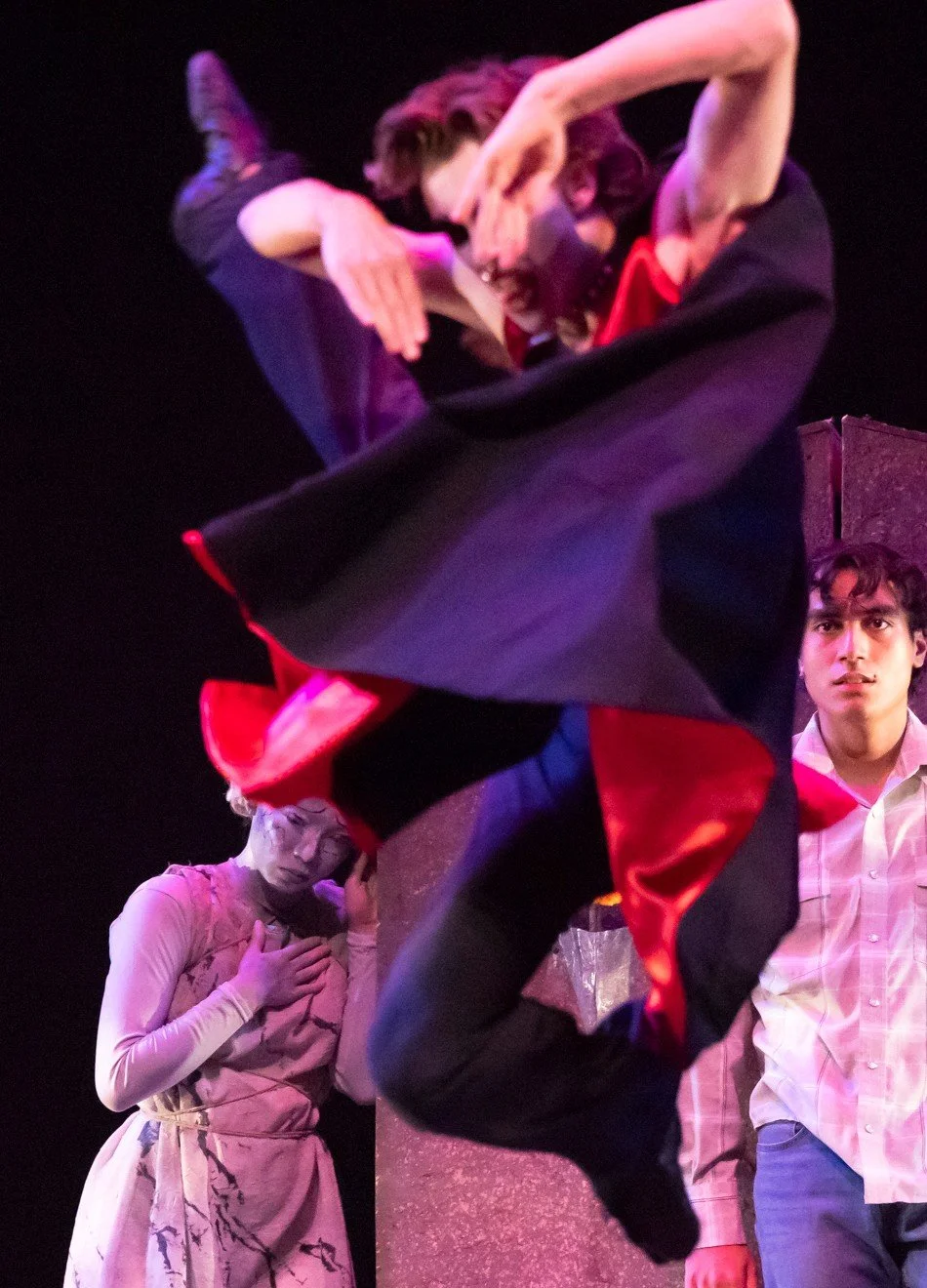 ZEWJ in a cape mid-jump, with hands over his face.