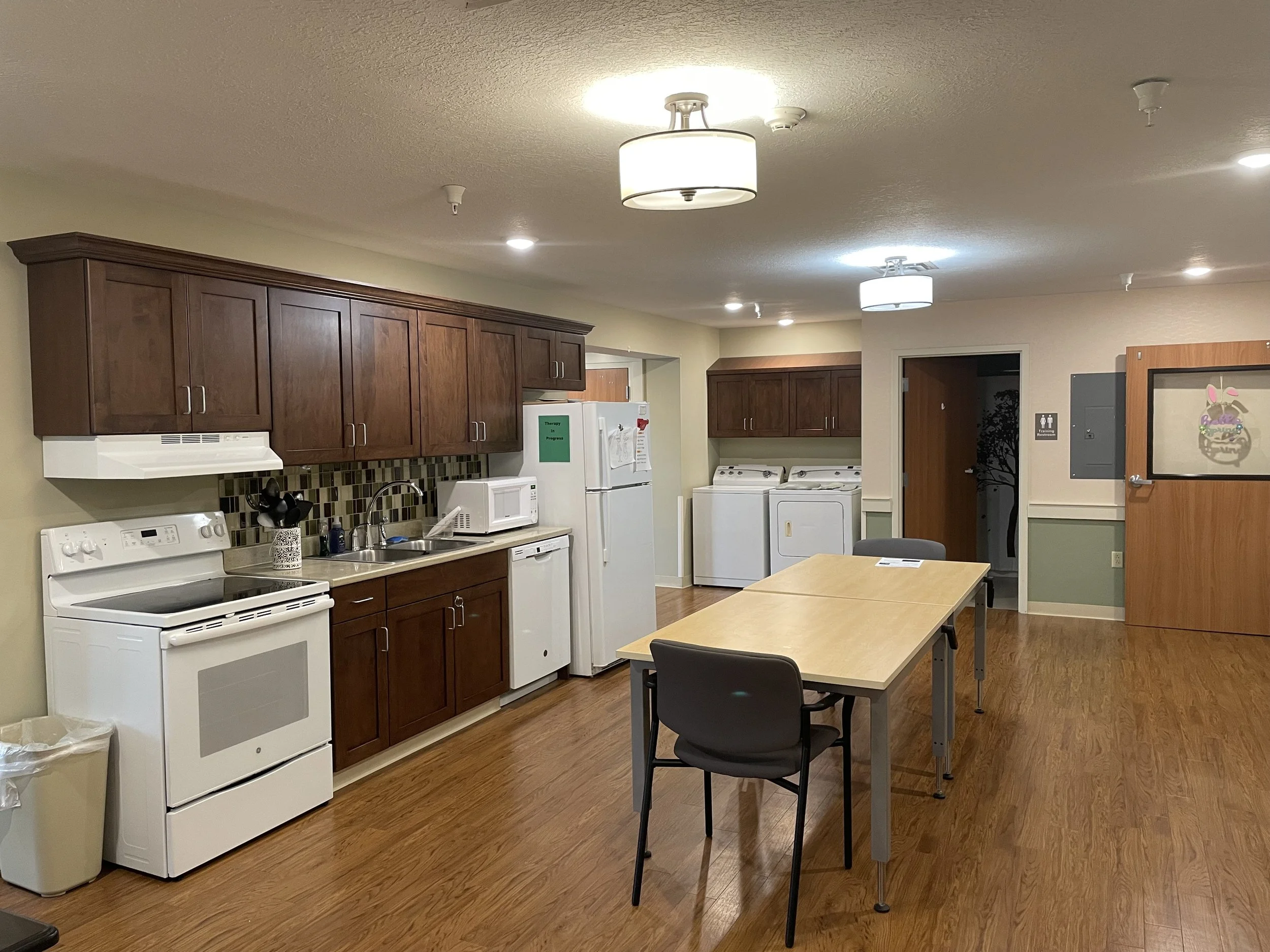 Fully equipped kitchen connecting to the Therapy Room.