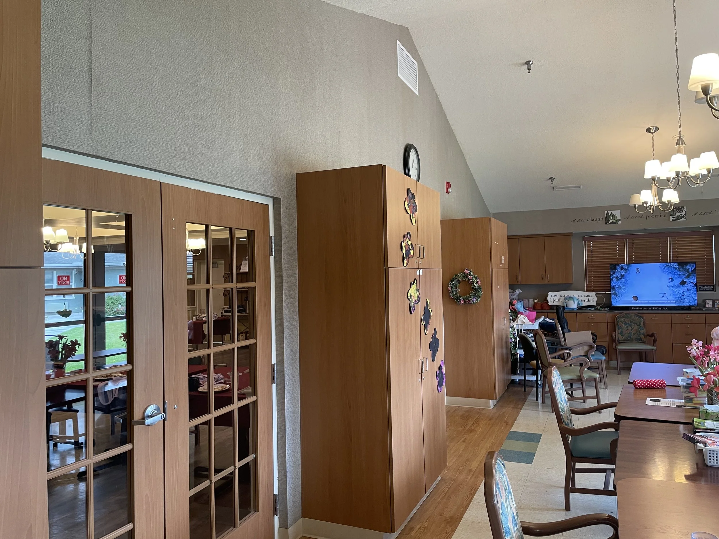 "Spacious activities and common area at Fieldstone Nursing and Rehabilitation Center with dining tables, seating, and entertainment space for resident engagement and social programs.