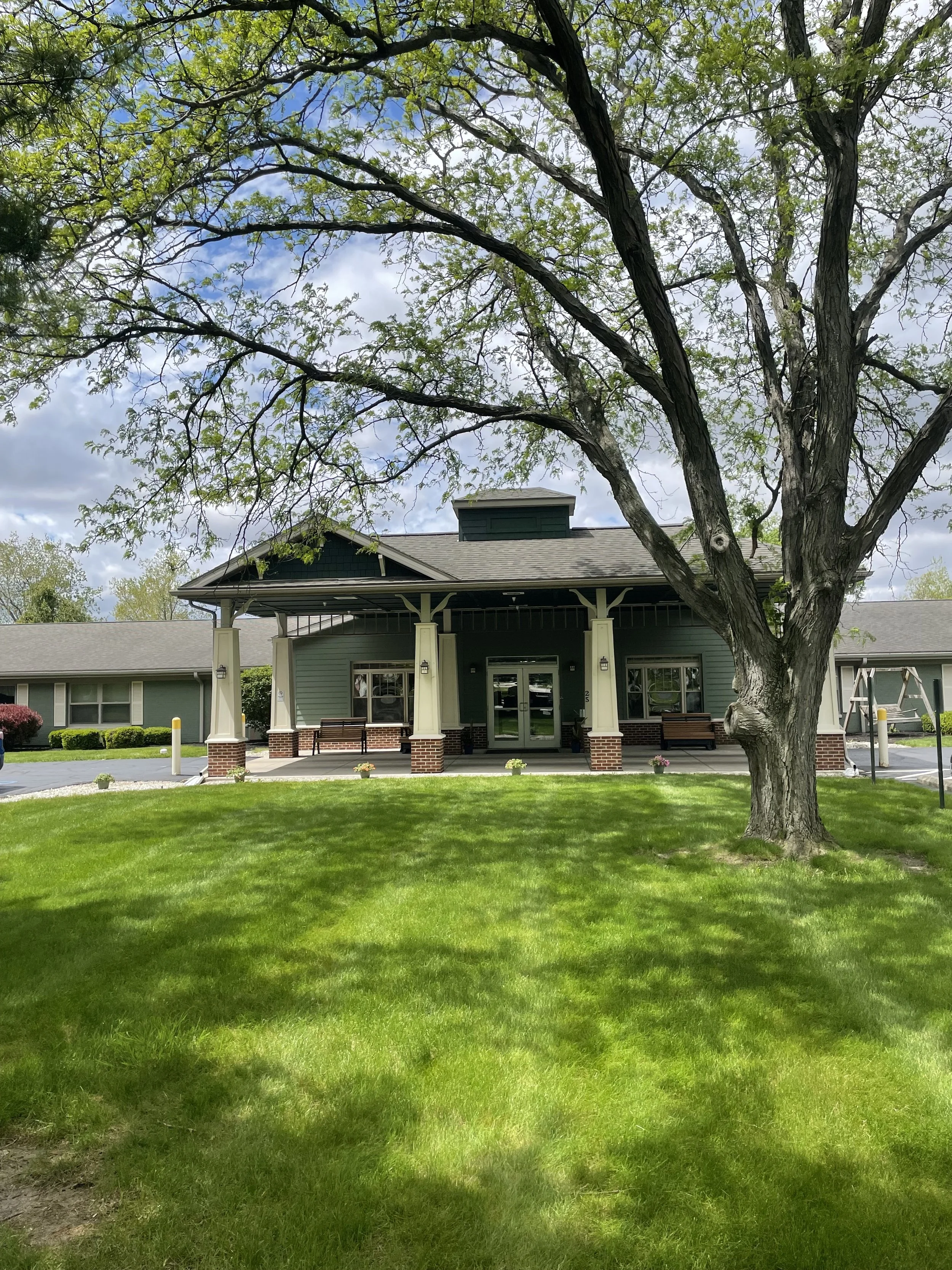 Front entrance of Fieldstone Nursing and Rehabilitation Center with covered porch and landscaped lawn.