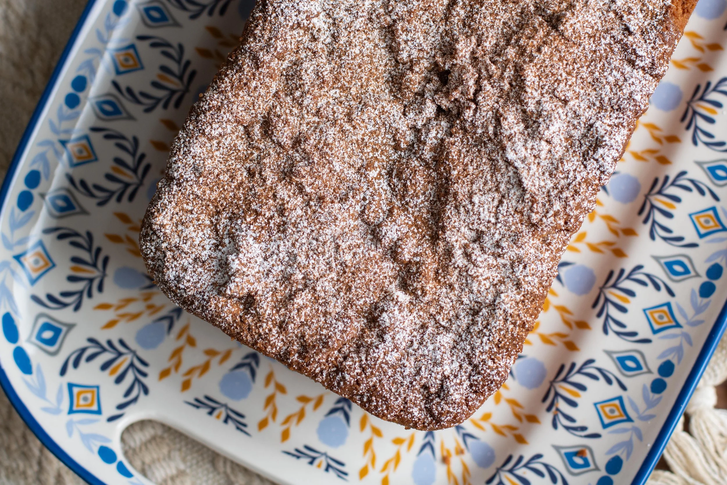 Baharat Coffee cake on a european style blue, yellow and white plate.