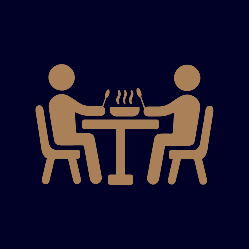 Two stylized figures sitting at a table with a steaming bowl of food, each holding a utensil.