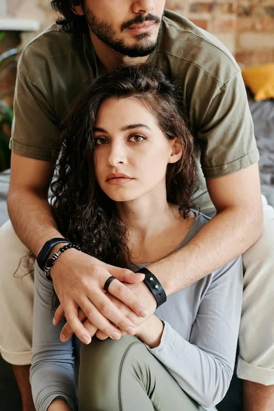 A couple hugging but we see only her face