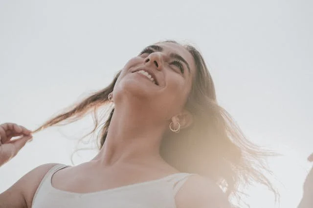 a smiling woman who is spinning