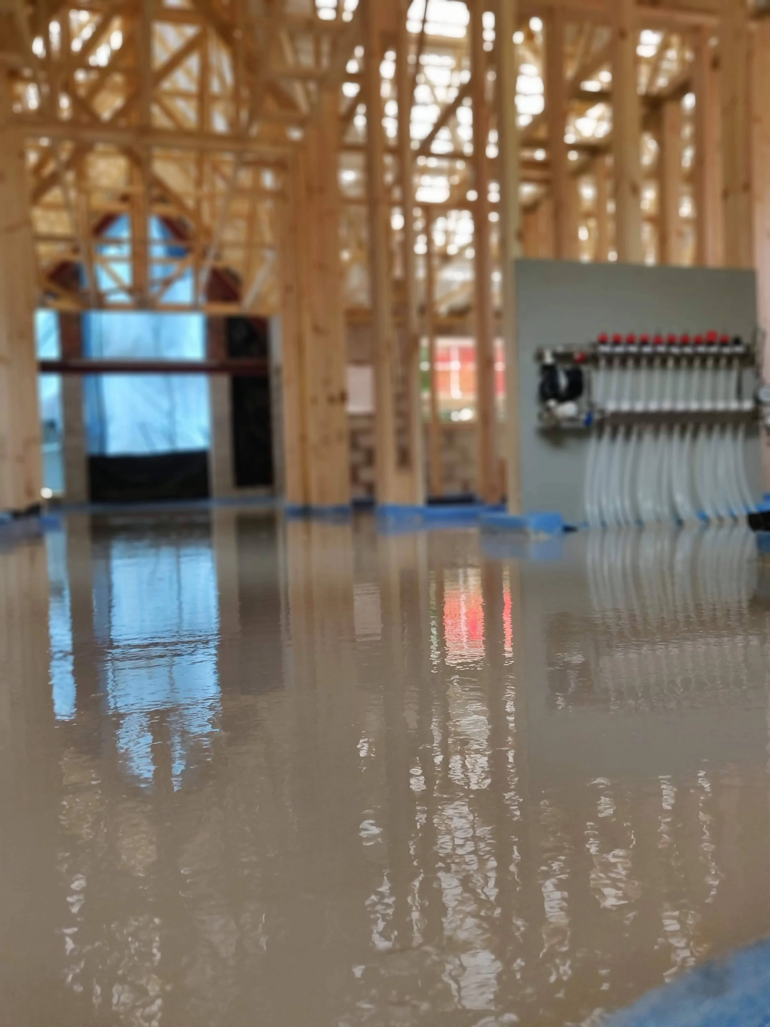 Construction site with unfinished wooden framing and a concrete floor in Worcestershire.