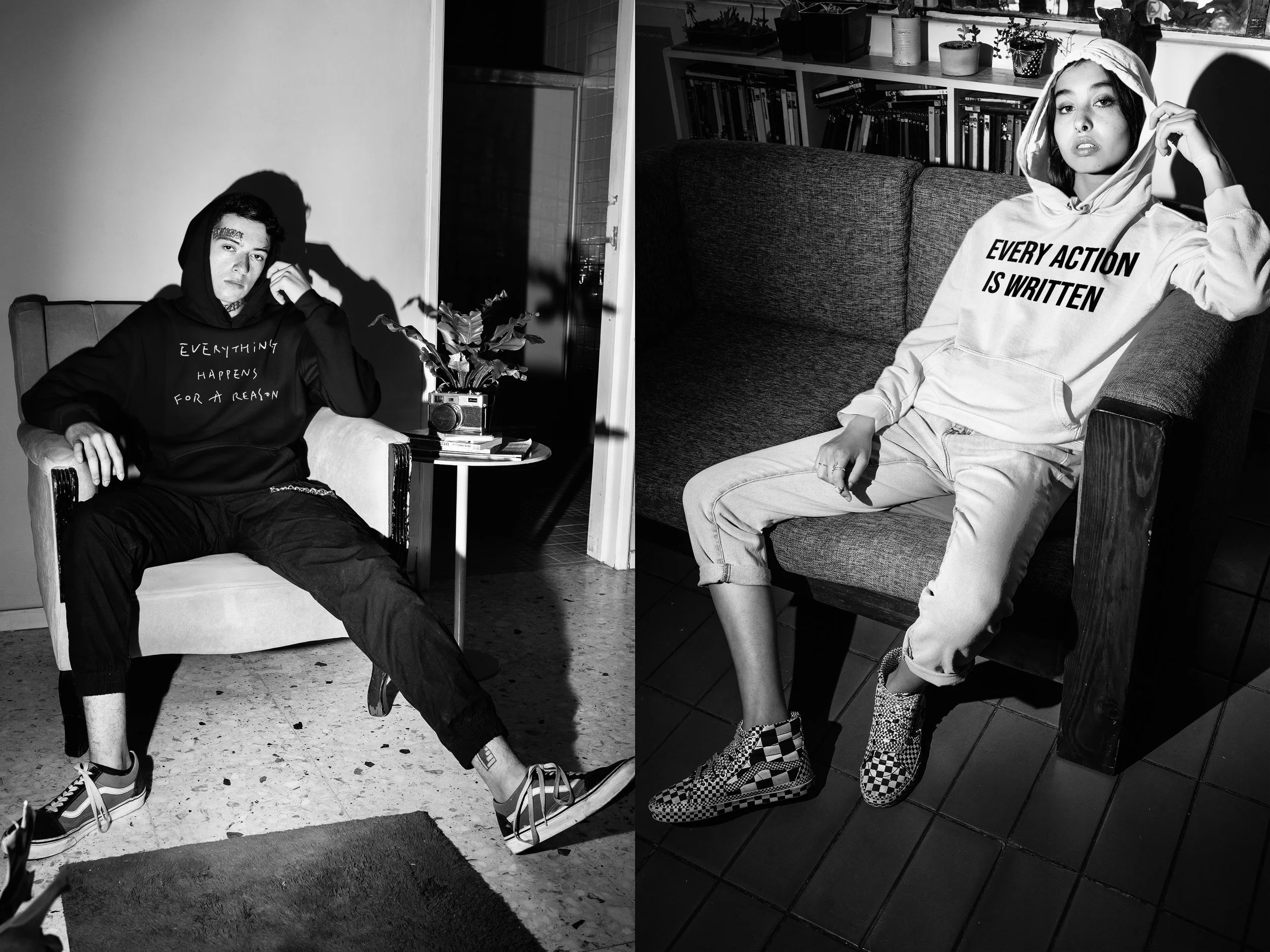 Black and white photo of a young man on the left sitting on a chair, wearing a hoodie that says "Everything Happens for a Reason", and a young woman on the right sitting on a sofa, wearing a hoodie that says "Every Action is Written." They are in an 