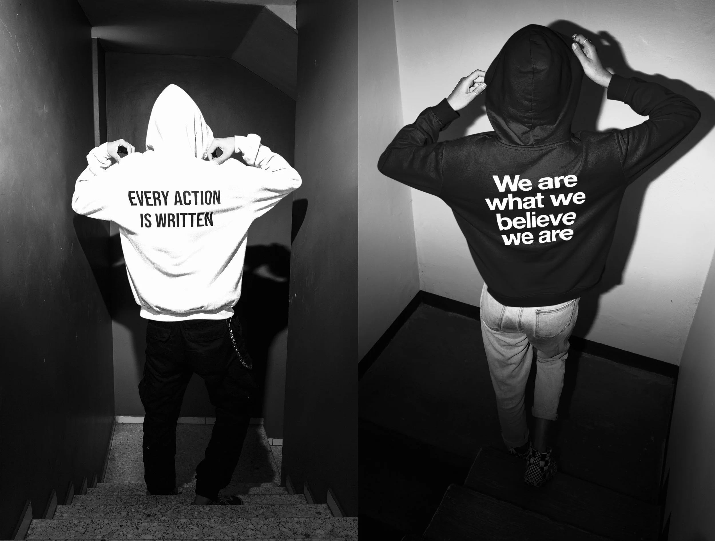 Two individuals wearing hoodies with inspirational quotes on the back, standing on stairs in an indoor setting. The left hoodie reads 'Every action is written,' and the right hoodie says 'We are what we believe we are.'