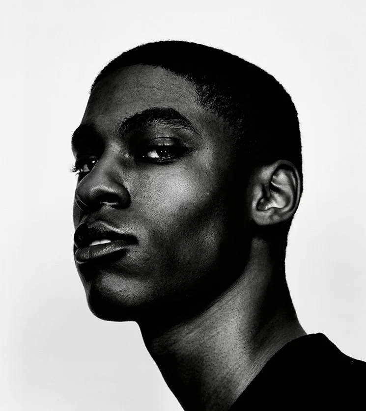 Black and white portrait of a young woman with short hair, looking slightly to the side.