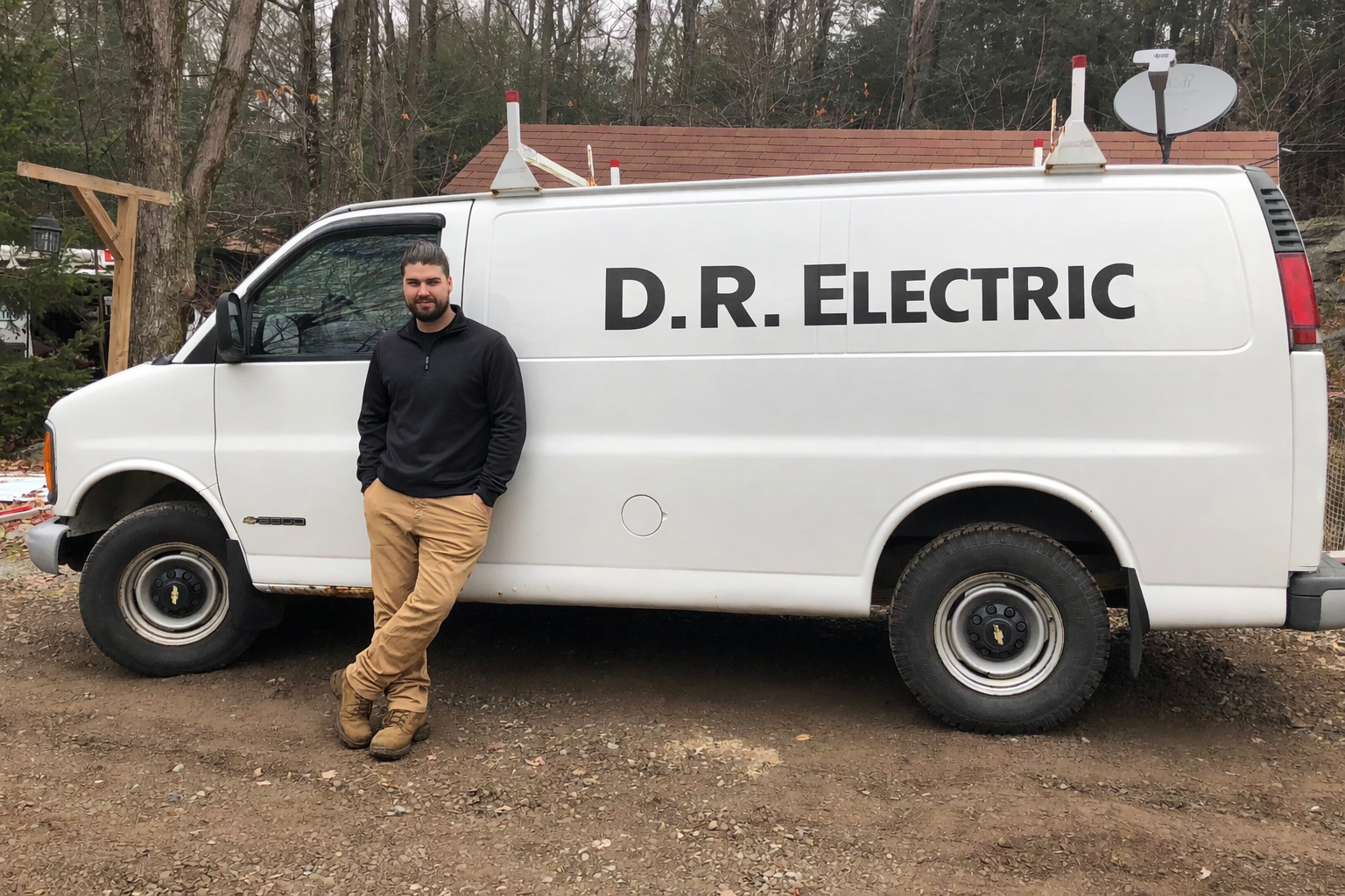 Local NEPA electrician standing beside a D.R. Electrical service van, representing reliable residential electrical services in Northeastern Pennsylvania.