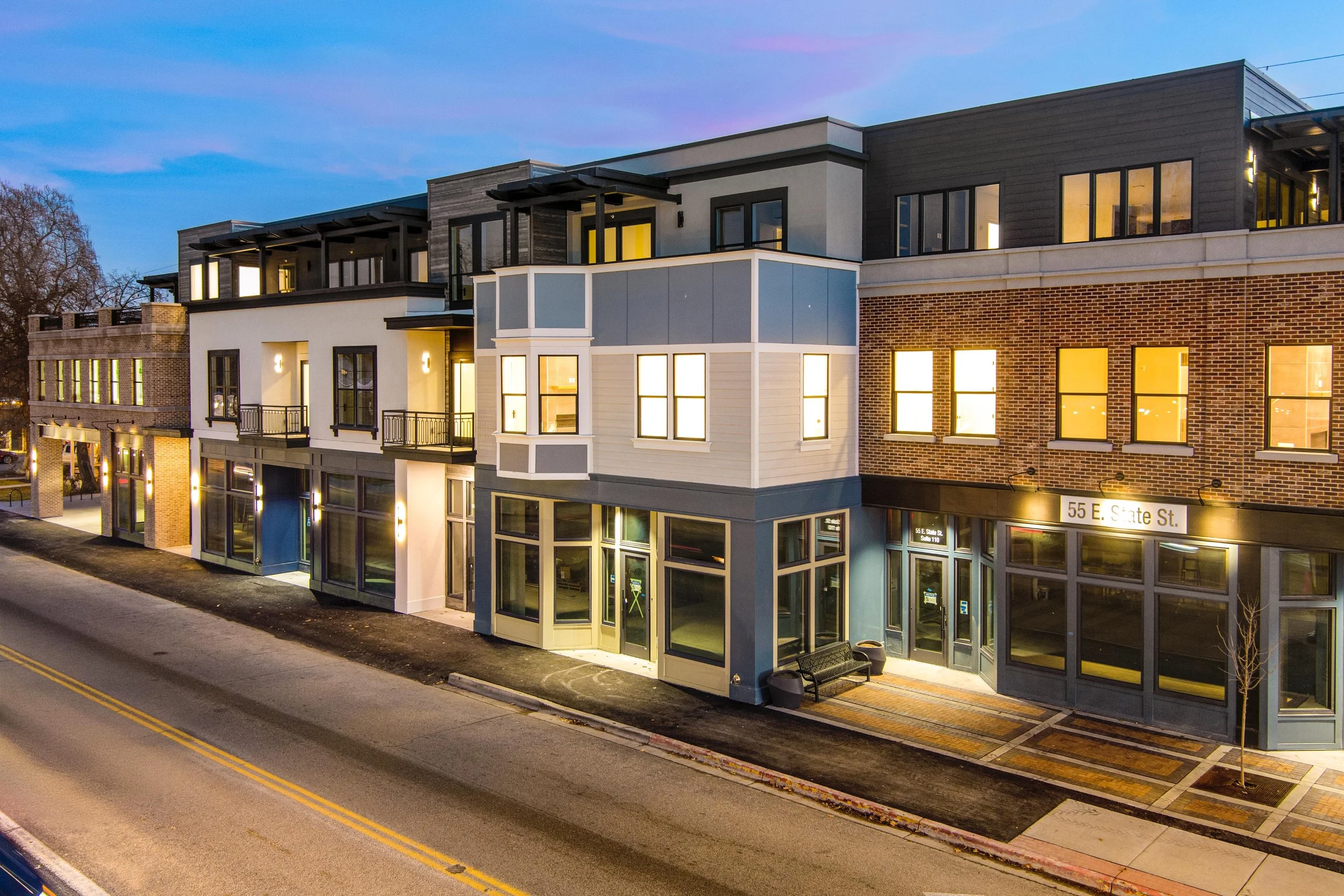 Aerial dusk view showing ground-level commercial spaces at The Hemingway in Downtown Eagle, Idaho.
