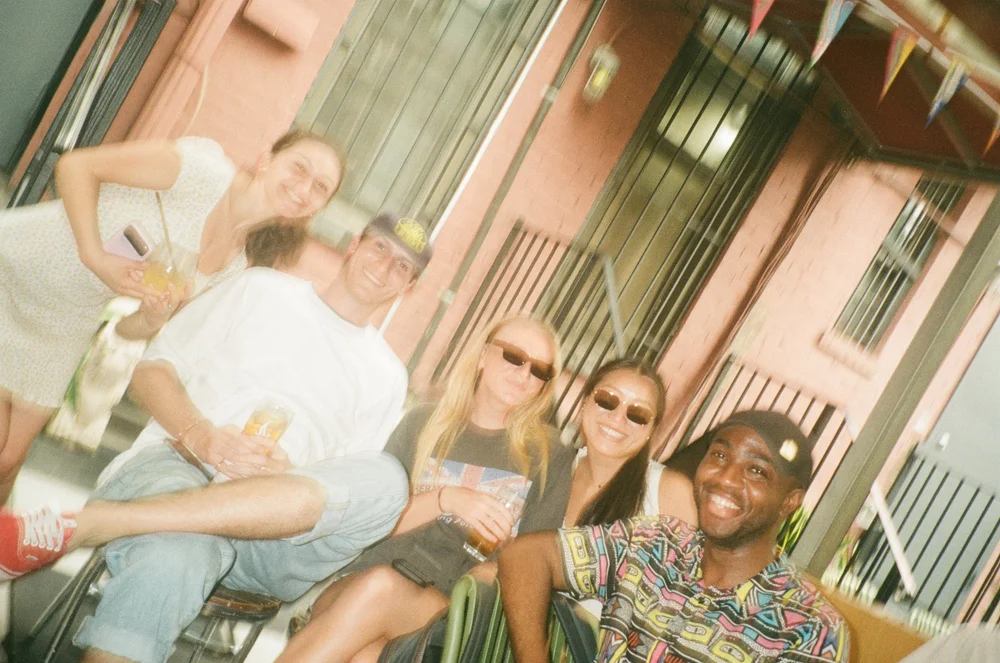 Team hanging out on a stoop, shot on film