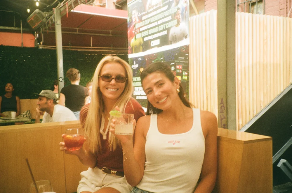Two teammates with drinks, shot on film