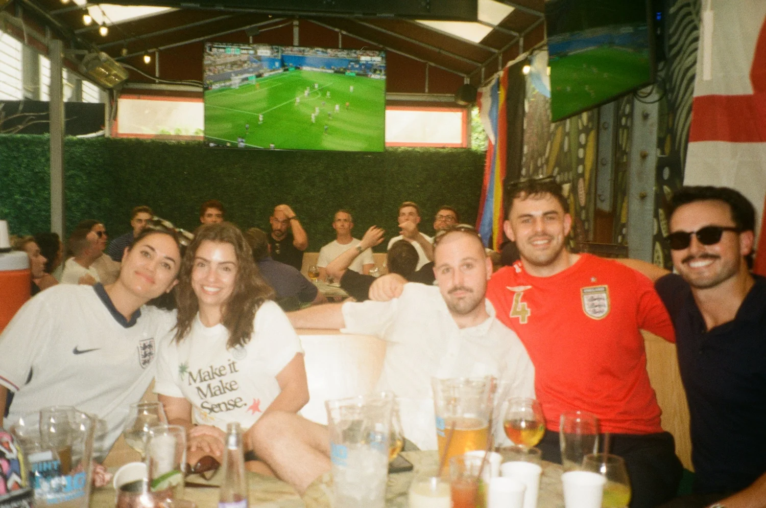 The team around a table at a World Cup watch party, shot on film