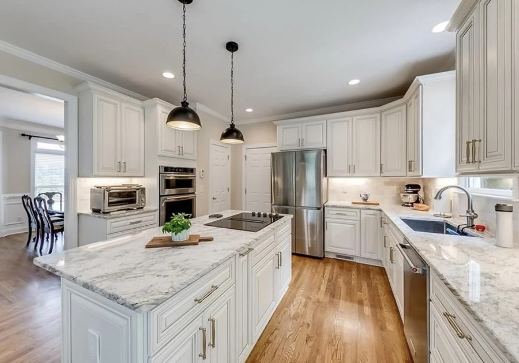 Traditional white kitchen with island and warm hardwood flooring