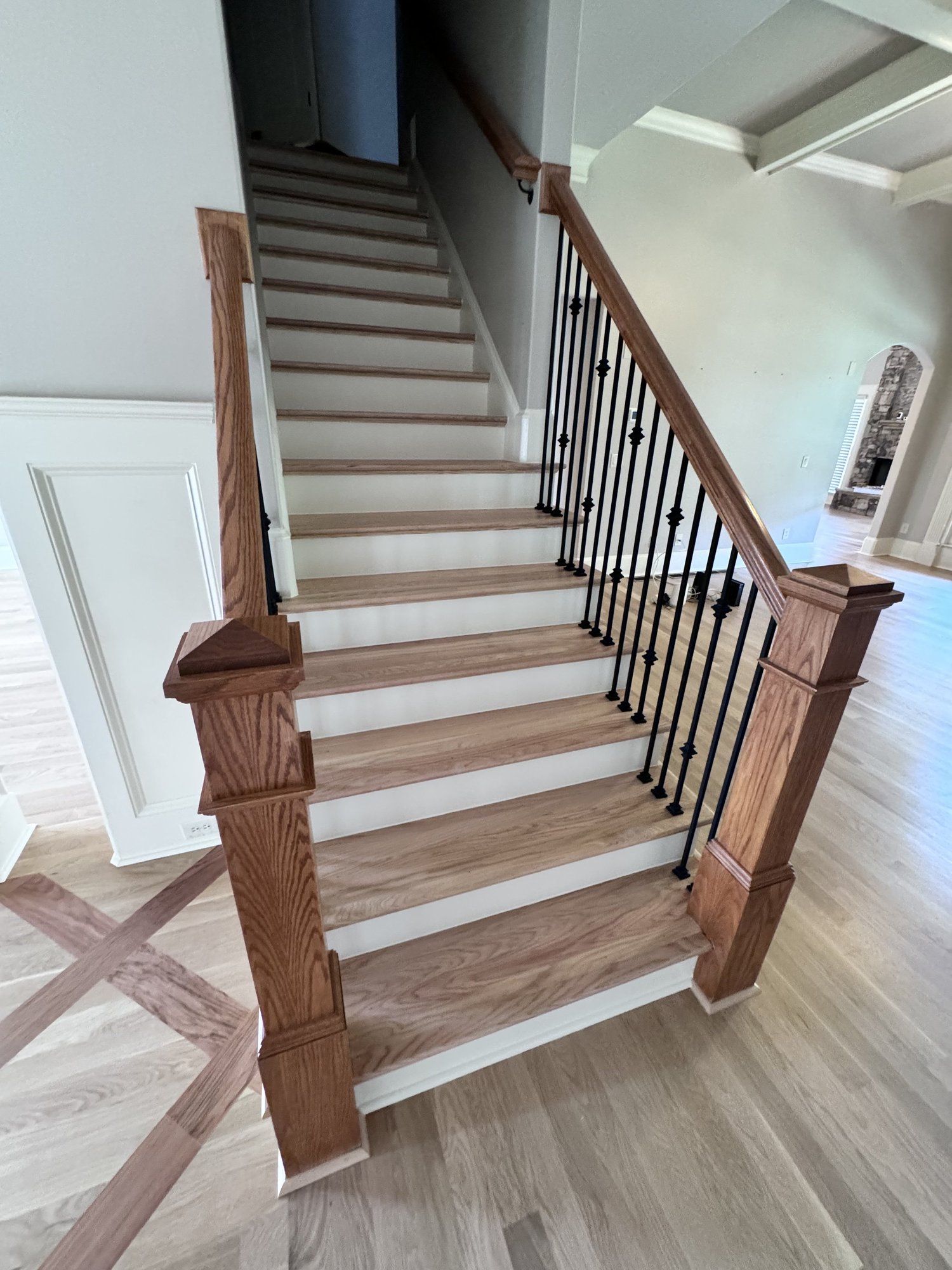 Wood staircase with black metal balusters