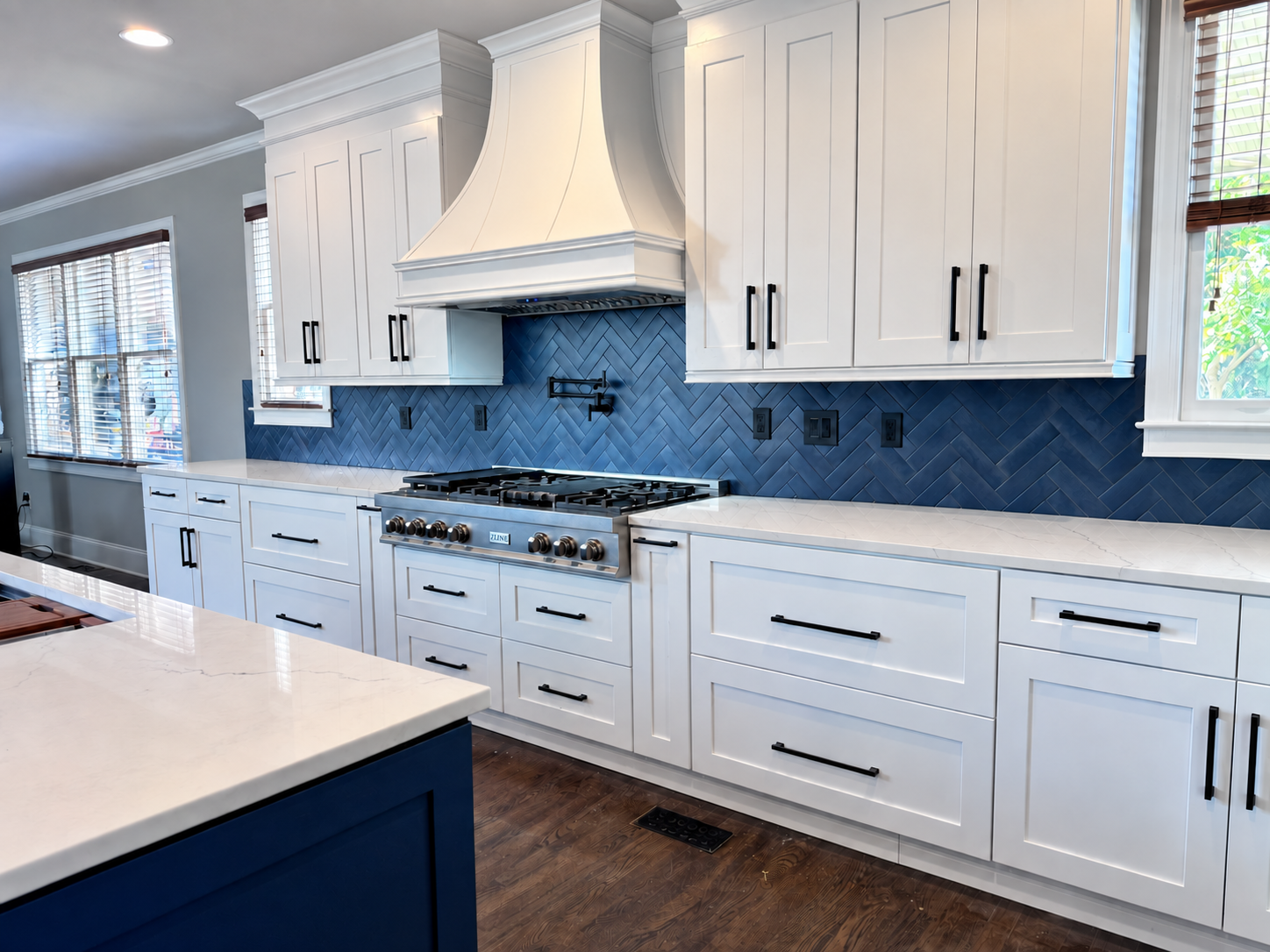 White kitchen with blue herringbone backsplash