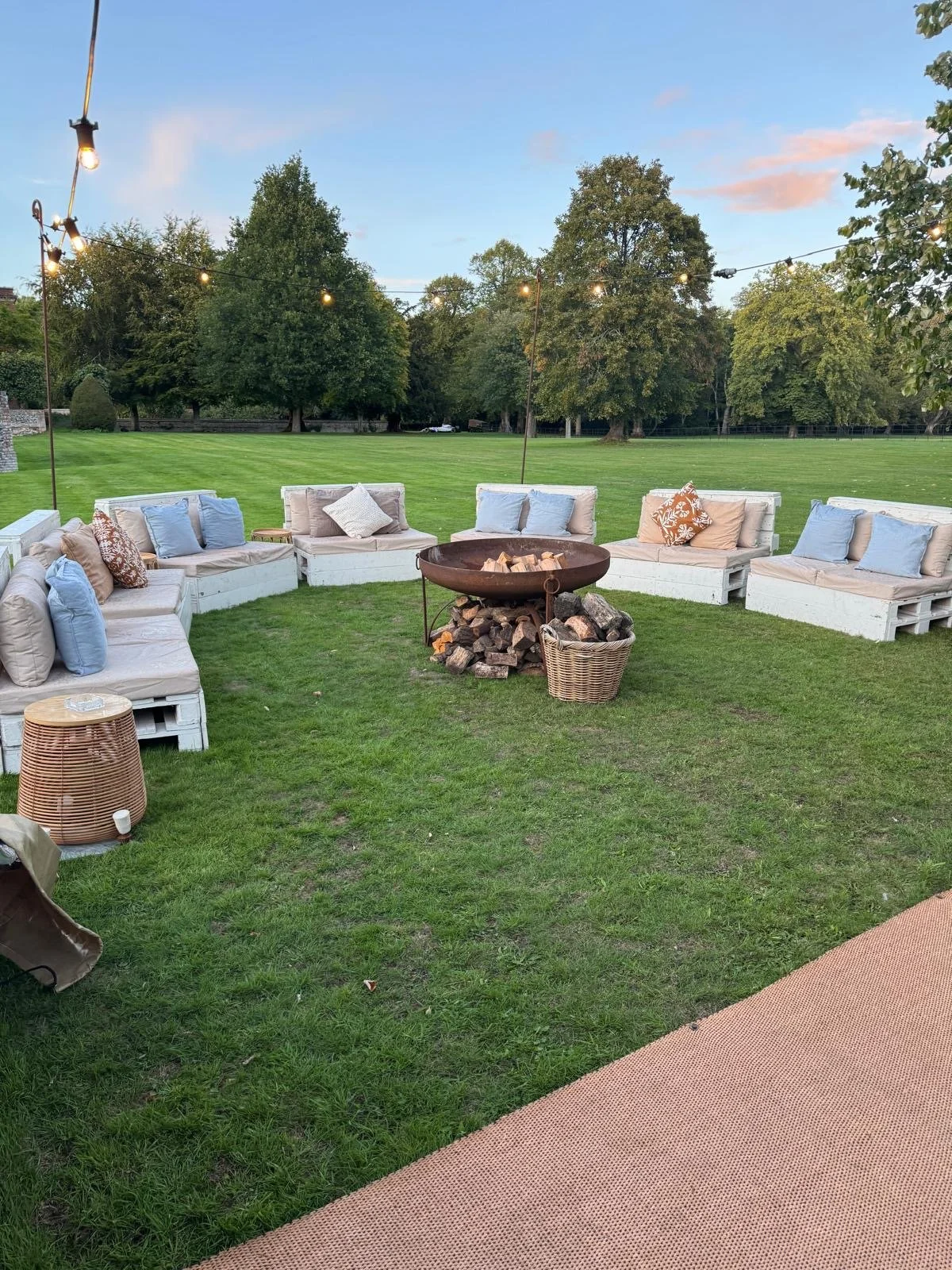 Minimalist illustration of a park bench with a tall tree and bush behind it.