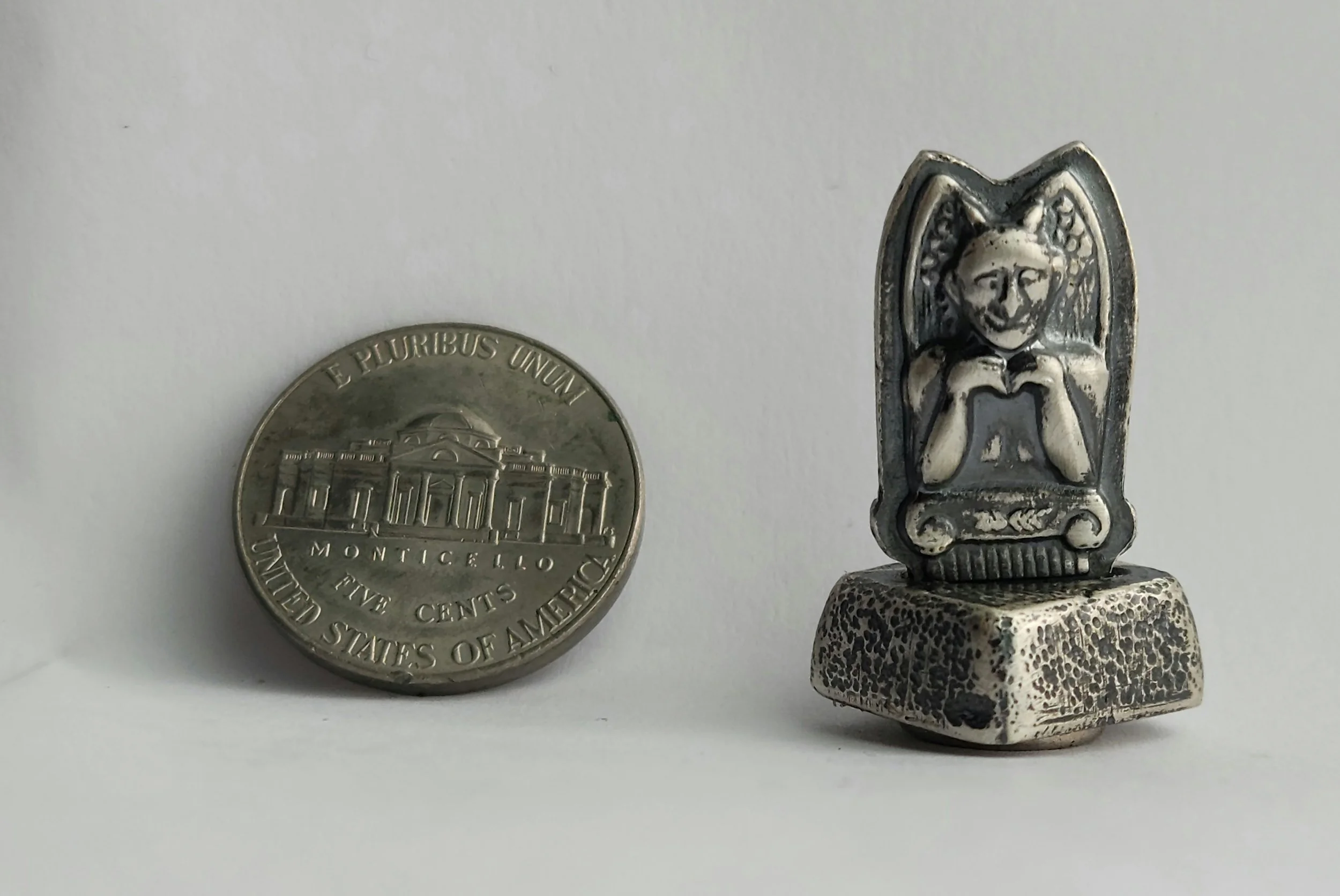 Die-struck, sand cast, and fabricated sterling silver gargoyle totem with magnetic base.