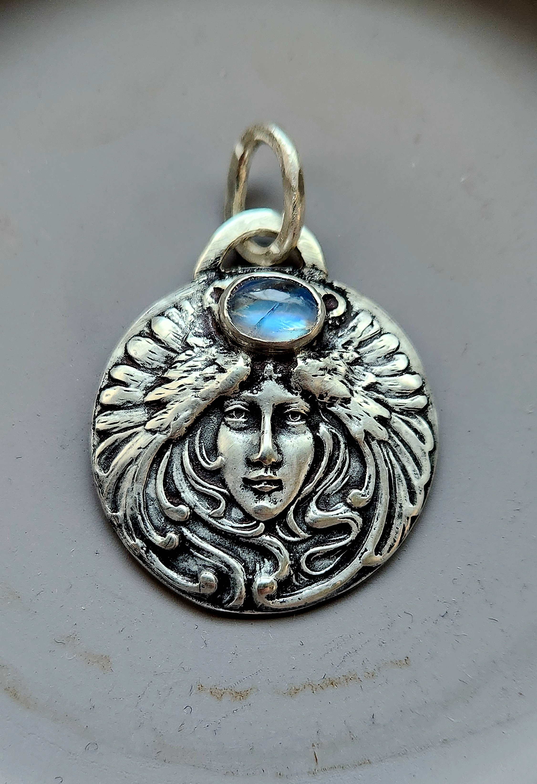 Die-struck solid silver pendant necklace with feather headdress woman cameo and moonstone.